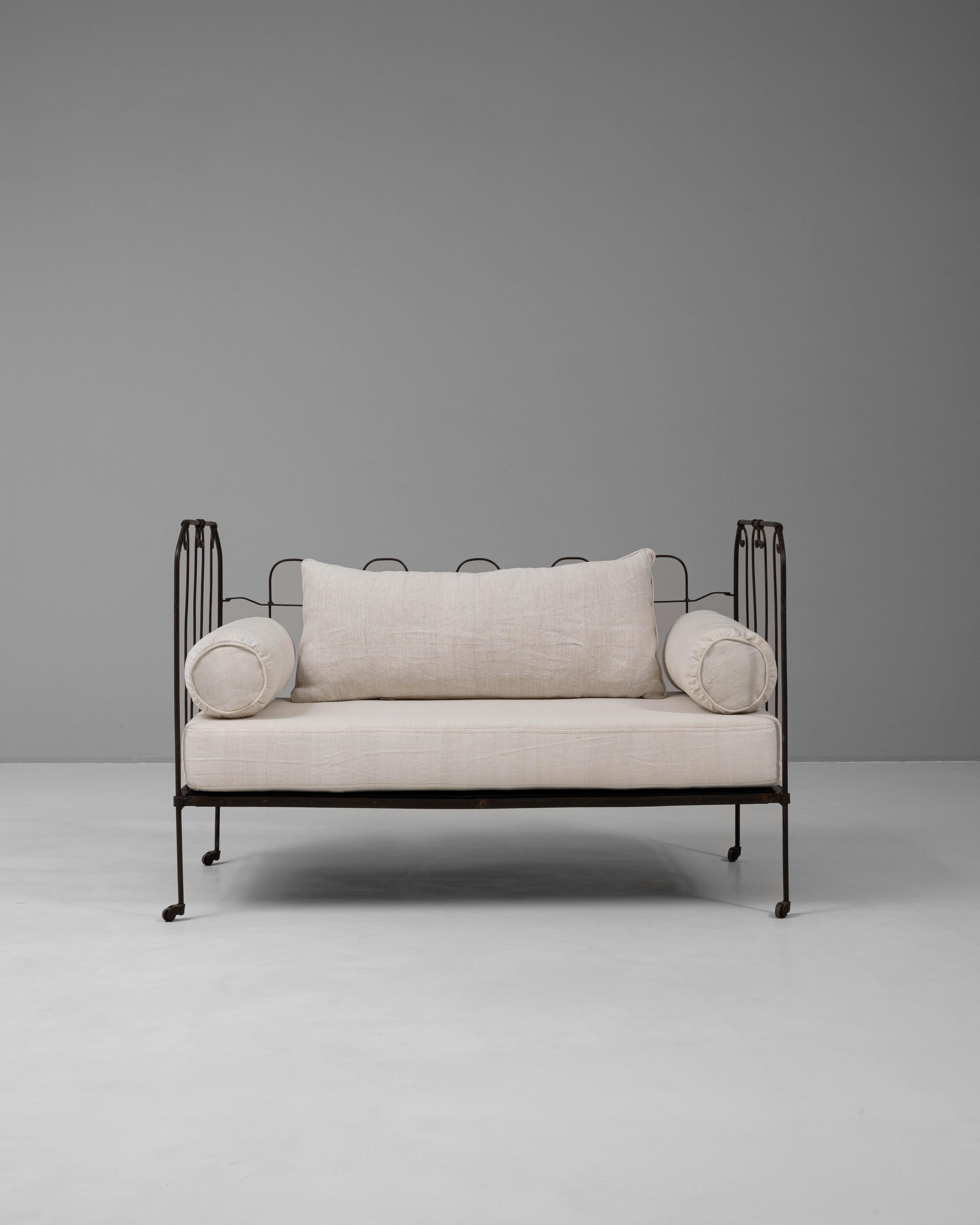This 19th Century French metal daybed showcases a timeless design with its elegant iron frame and original patinated finish. The intricate scrollwork and delicate craftsmanship highlight the sophistication of French furniture from this era. Set on