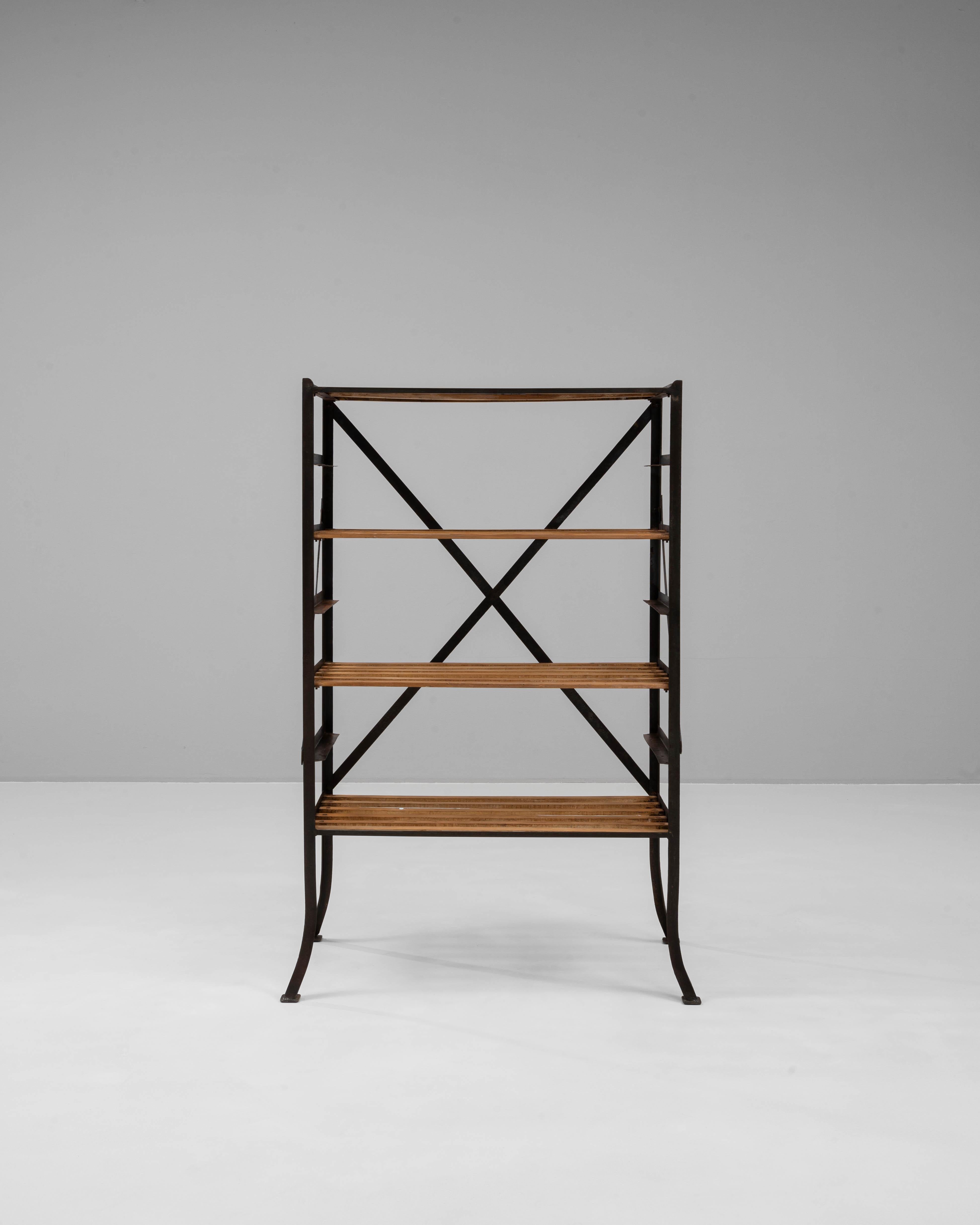 Questo scaffale francese del XIX secolo combina il fascino rustico con l'eleganza industriale, rendendolo un'aggiunta versatile a qualsiasi spazio. Caratterizzata da una robusta struttura in metallo con dettagli a croce per una maggiore stabilità,