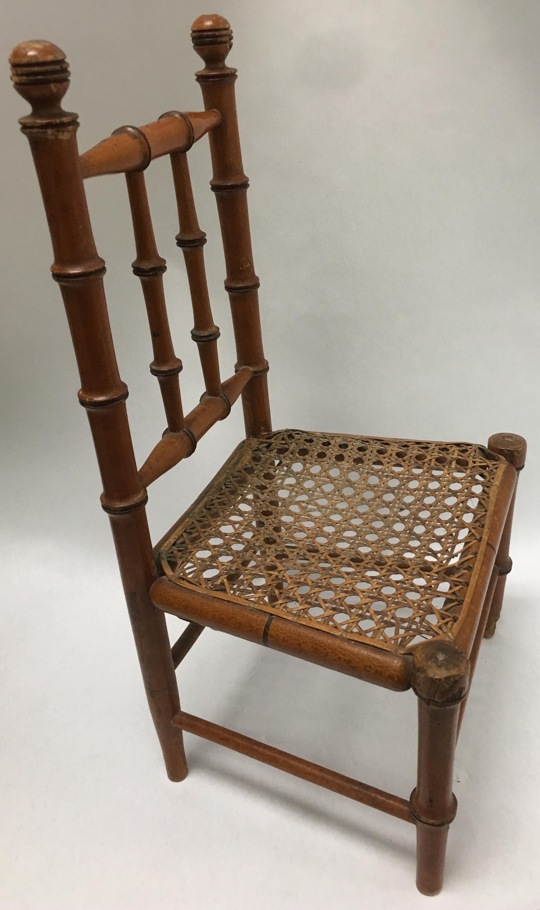 19th century French miniature fruitwood faux bamboo carved wood chair with original caned seat. Seat is 6
