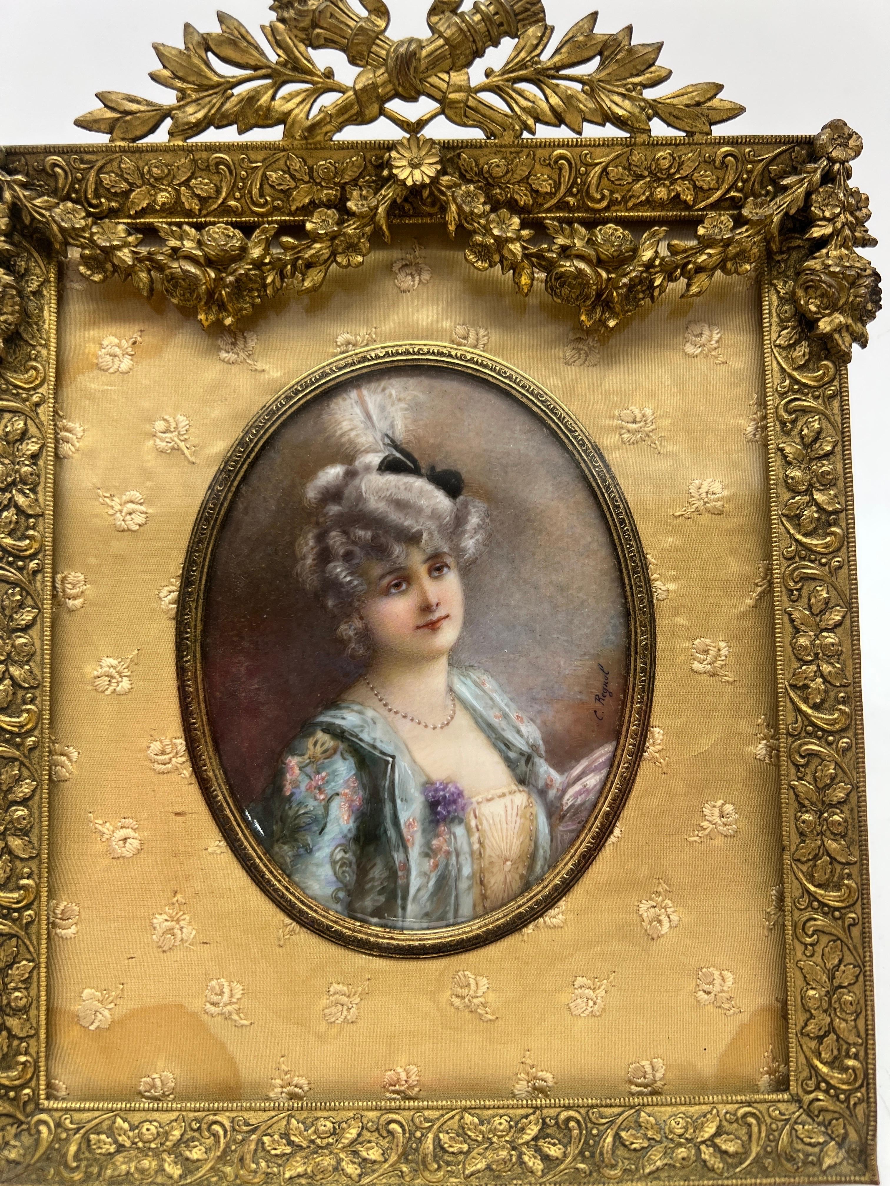 French, 19th century.

A fine quality 19th century French miniature painting of beautiful lady. The oval painting is housed under a domed glass shield, surrounded by delicate silk embroidered with flowers and housed completely in a D'ore bronze