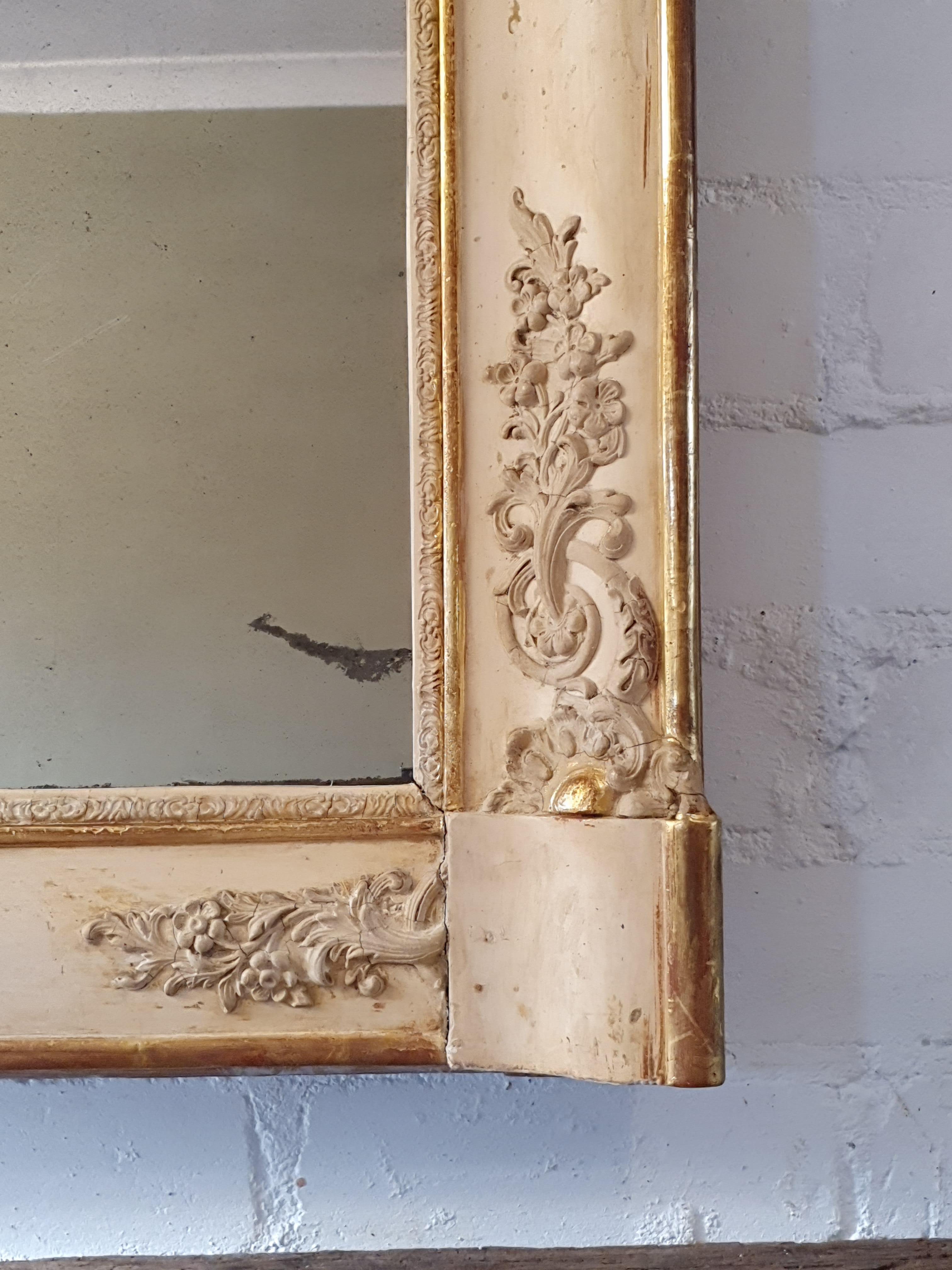 Early 19th century rectangular French wall / mantel mirror. Distressed finish, some of original gilding remains, contains original mercury glass witch sings of age (black spots, scratches etc). Very decorative with floral ornament.