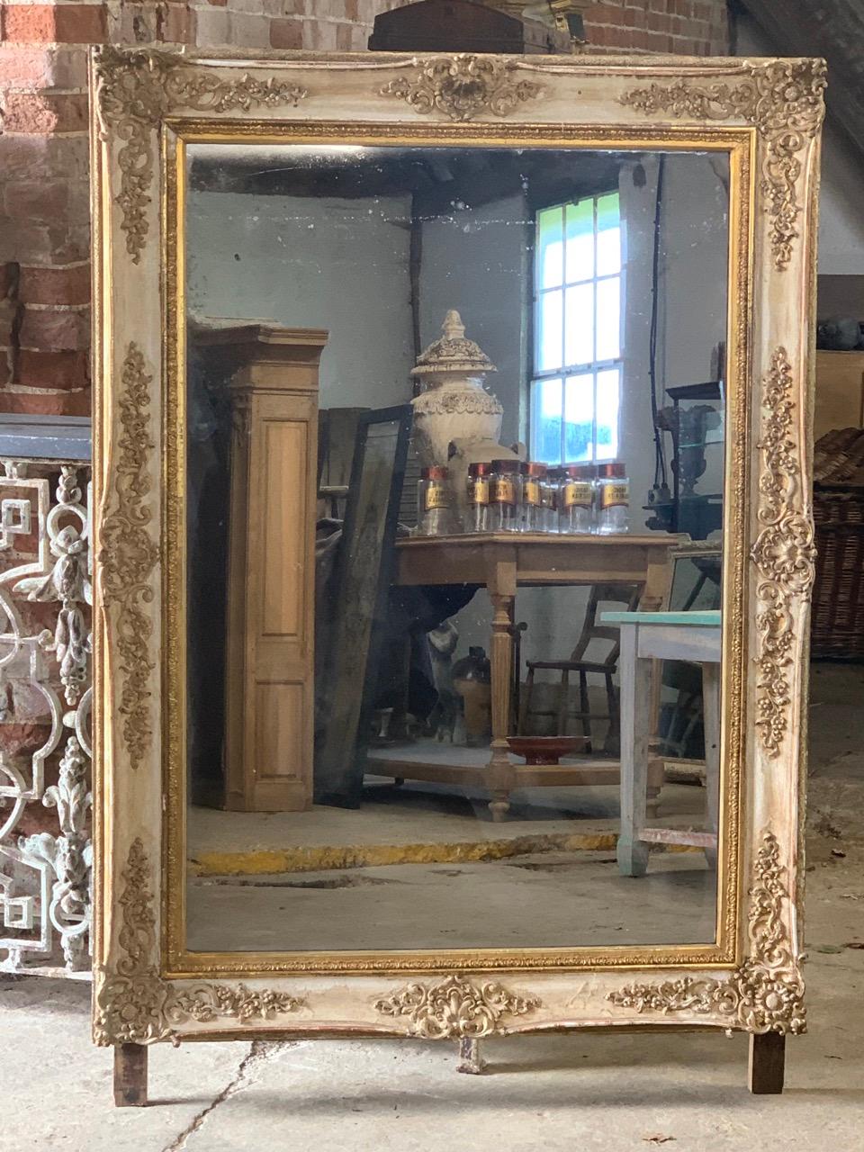 A beautiful 19th century French mirror with lovely natural wear to the gilding. With original foxed mercury mirror plate which twinkles when it catches the light. 158cm high with the feet. Later backboard.