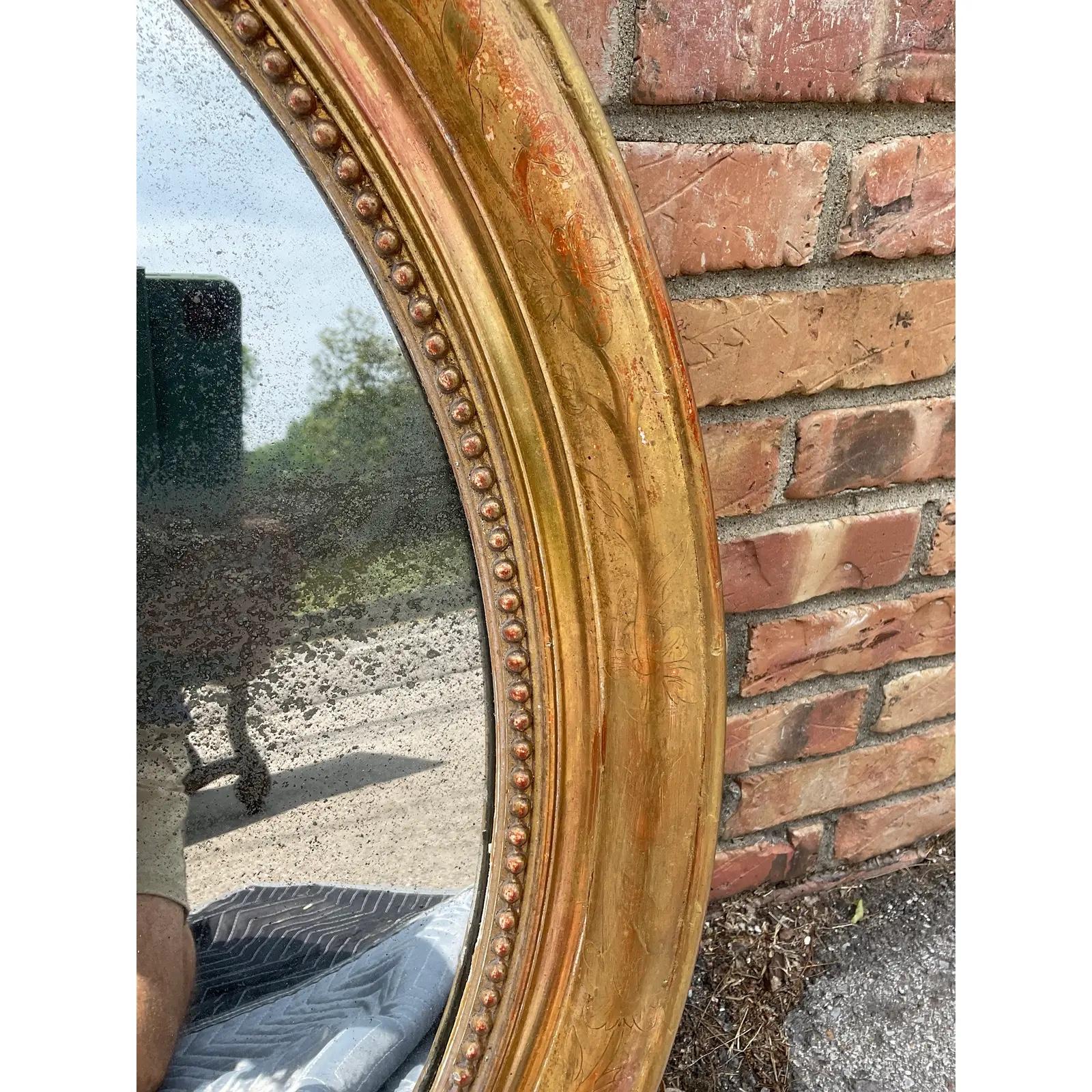 This is a beautiful 19th century French mirror. It features an intricate hand carved floral and leaf design on the edges and a beaded inner border. Mirrors of this style are quite versatile and can be beautifully displayed in traditional or