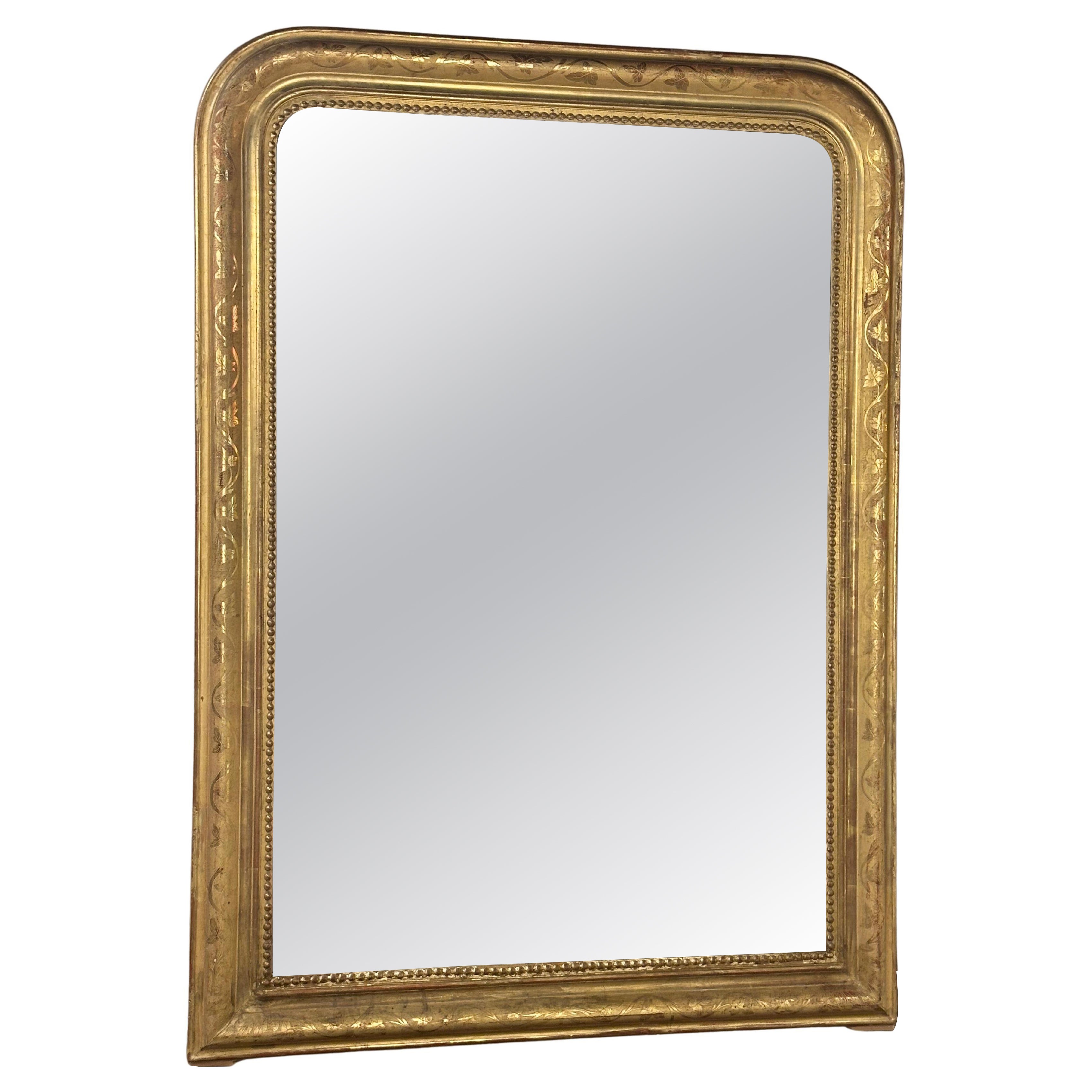 19th century French mirror in gilded wood with floral decorations