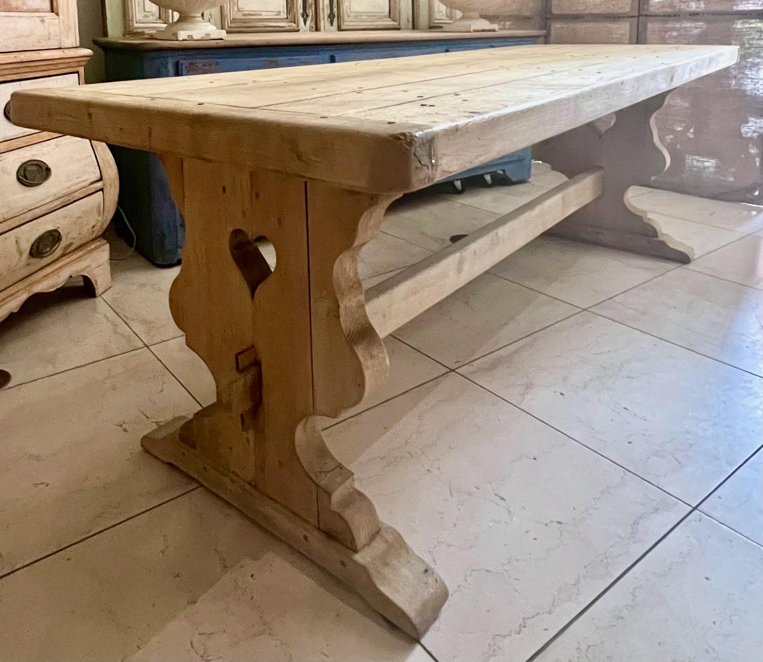 Late 19th/early 20th century French, grand scale solid oak Monastery style table.
Sturdily constructed from solid blonde oak with trestle, mortise and tenon joinery base holding very thick solid plank top.
Top, ends bases and stretcher can take