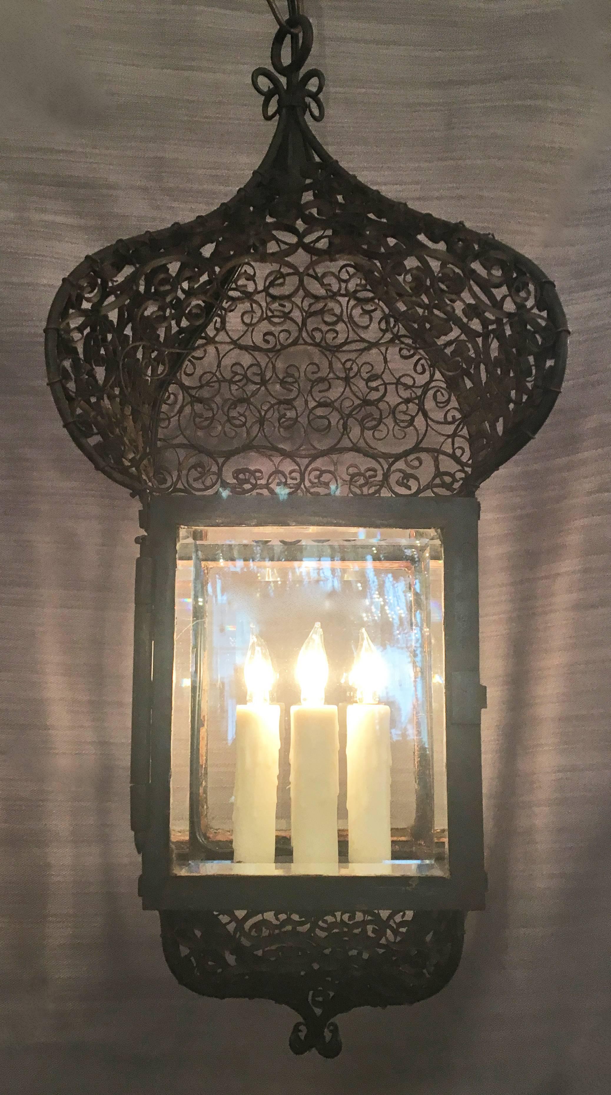 This French Moroccan lantern in the Moorish style was originally kerosene and has since been rewired and electrified. Intricate iron scroll work with Middle-Eastern Asian influence. 

Comes with chain and canopy upon purchasing.