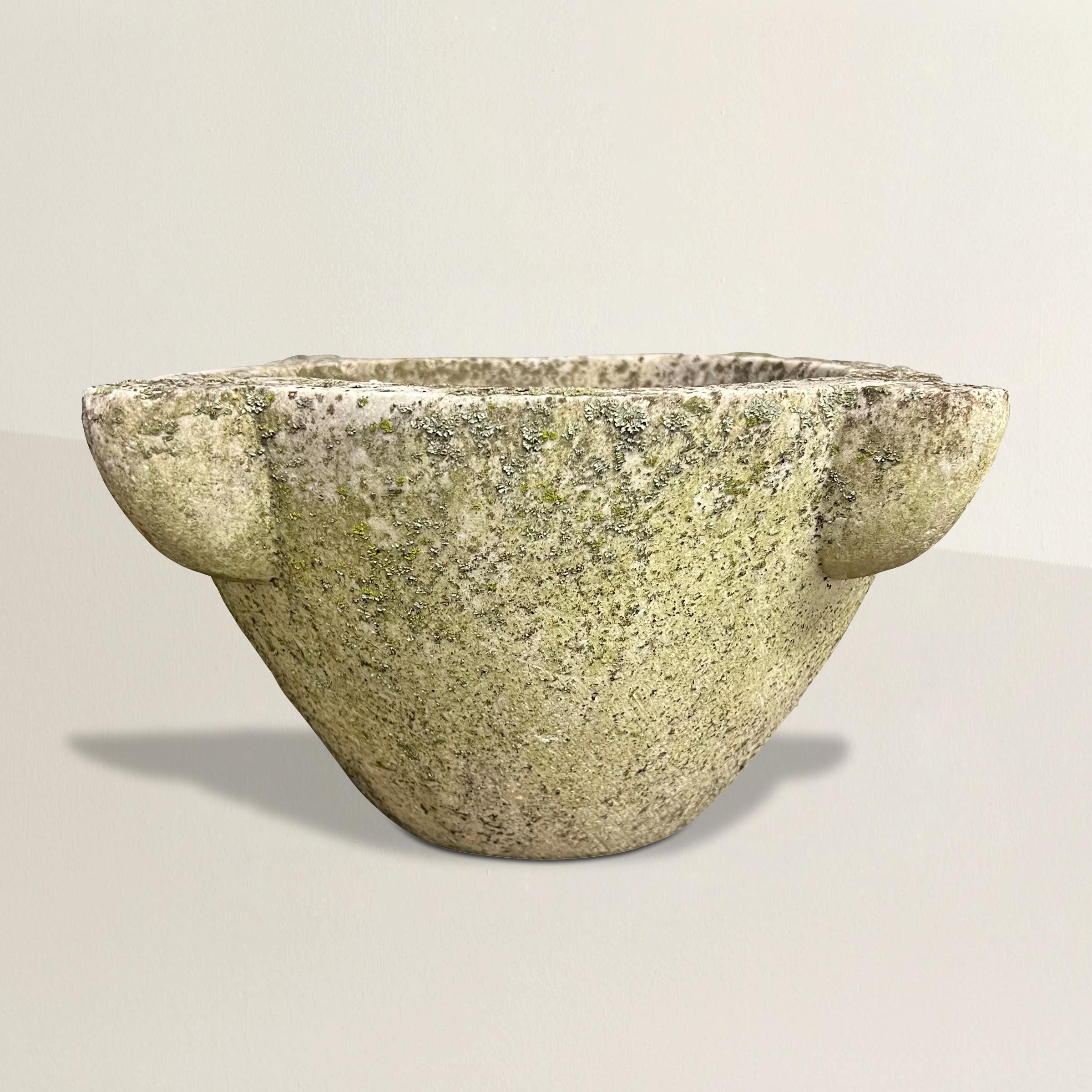 Step into a mesmerizing culinary journey with this 19th-century French marble mortar, gracefully adorned with the passage of time. Lovingly weathered by decades of exposure to the elements, its surface now boasts an enchanting patina of green mosses