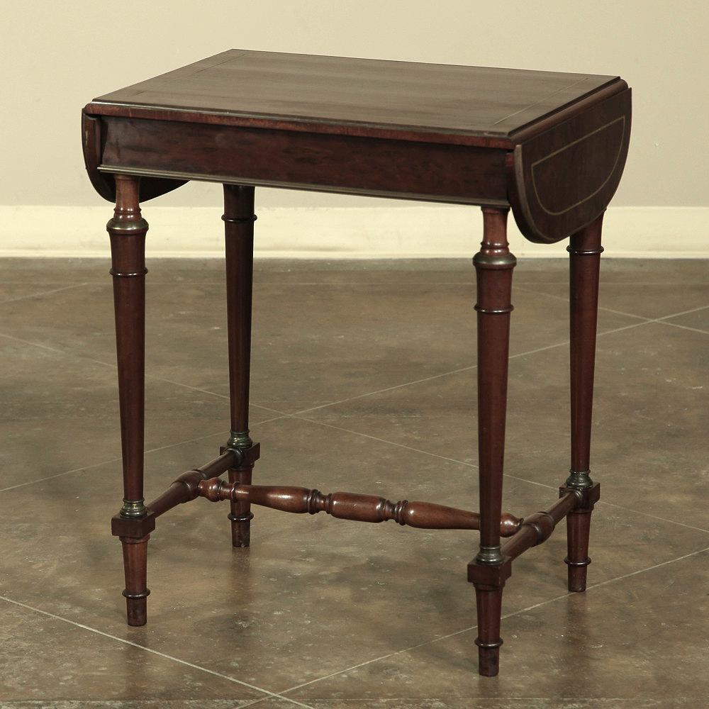 19th century French Mueche Mahogany drop leaf occasional table with brass inlay is as versatile as it is elegant. Crafted during the early Napoleon III Period out of exotic mueche mahogany, a rare variant of the exotic wood from the Americas that is