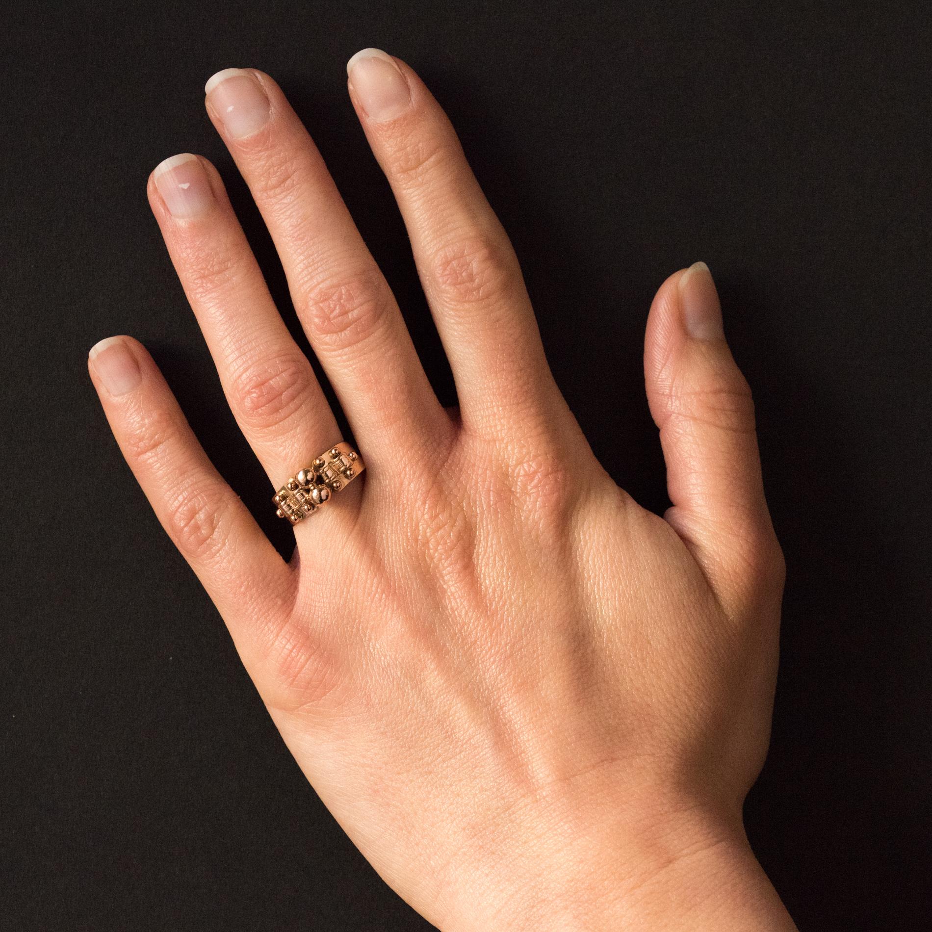 Ring in 18 karats rose gold, horse's head hallmark.
Lovely antique ring, it is set on the top with 2 gold pearls shouldered on both sides by a chiseled gold ribbon and 2 x 5 small gold pearls. The ring is then perforated.
Height: 8, 1 mm, width of