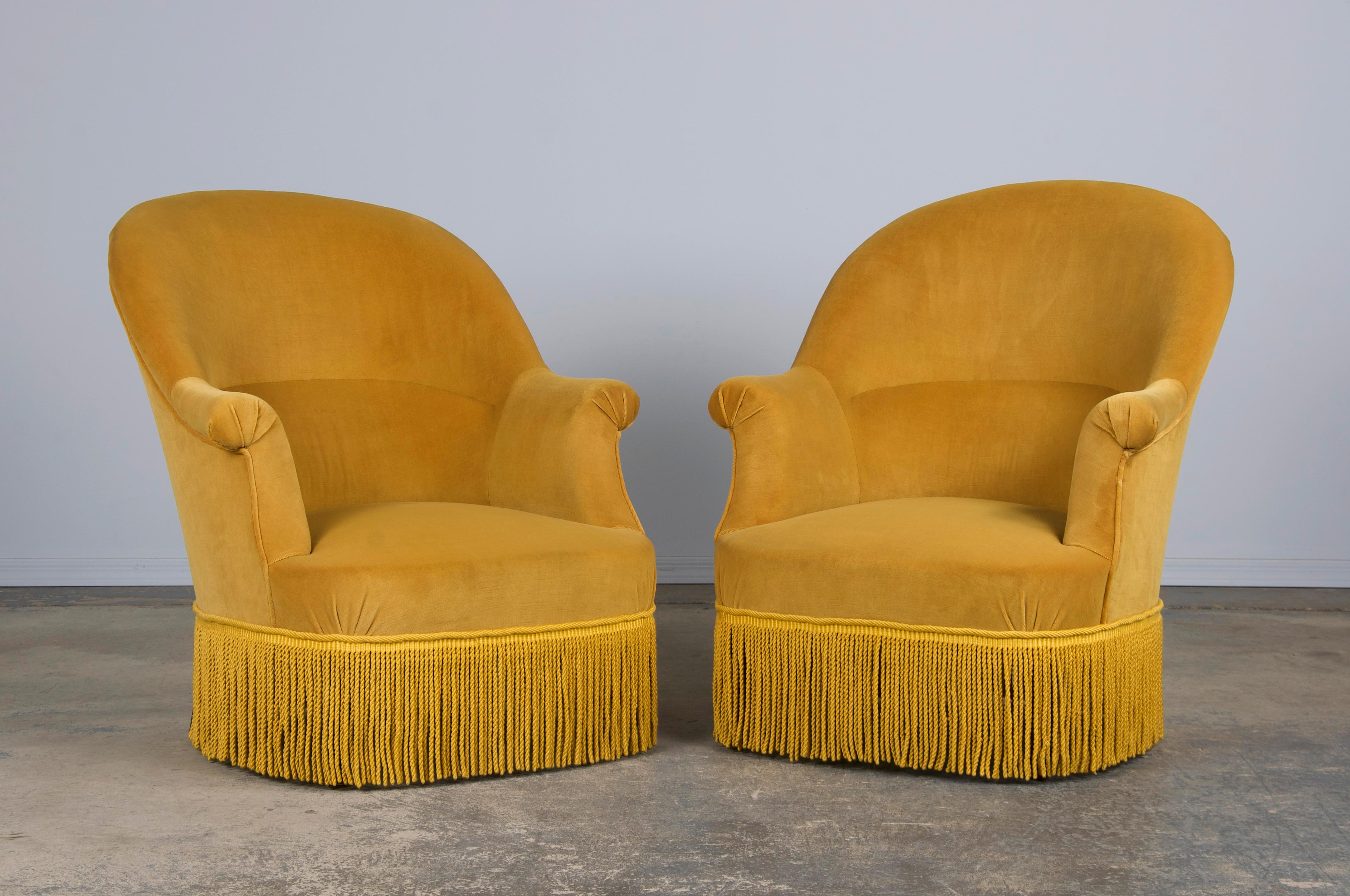 A traditional pair of late 19th-century Napoleon III armchairs, sourced from Provence, France. Beautifully handcrafted from solid wood, they feature elegant oval-back frames, scroll arms, and a classic 