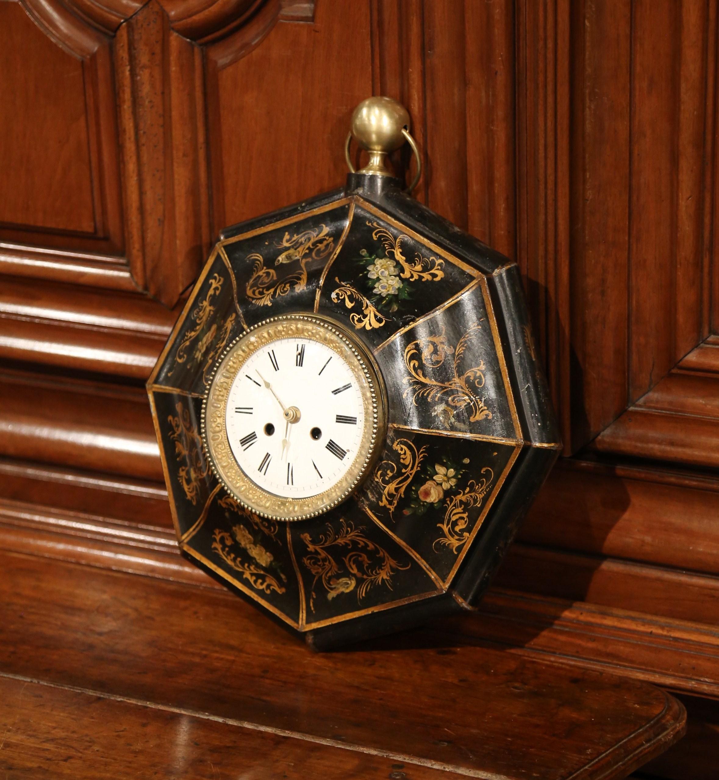 This feminine wall clock was created in France, circa 1870. Octagonal in shape, the antique tole clock features a round brass finial at the top. The mechanism inside the timepiece has been replaced with a quartz battery and keeps perfect time. The