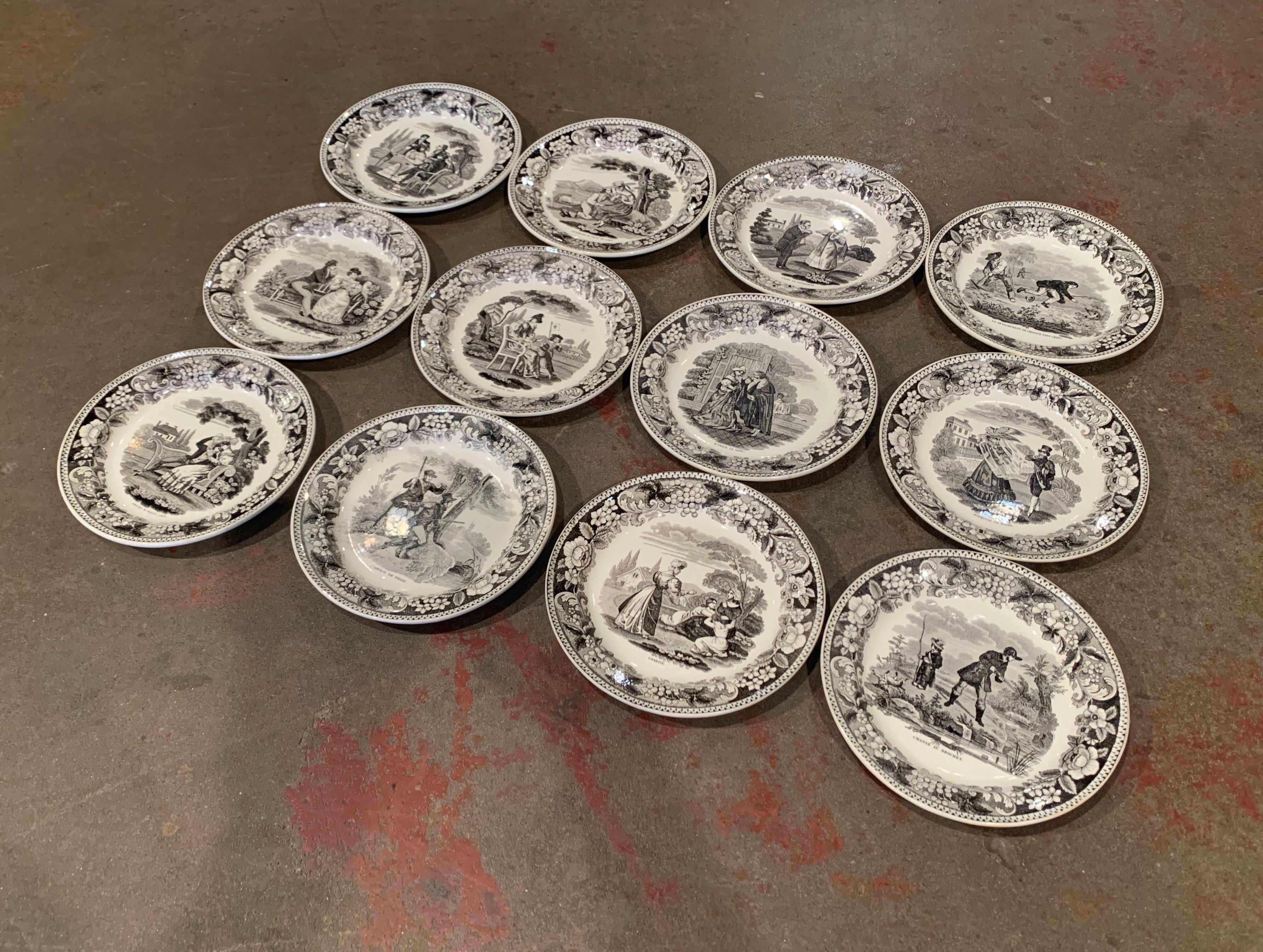 Use this elegant set of twelve antique plates to serve appetizer or desert to your guests! Crafted by Leboeuf et Thibault in Montereau, France, circa 1880, each hand painted ceramic plate features funny courting scenes or anecdotal daily events with