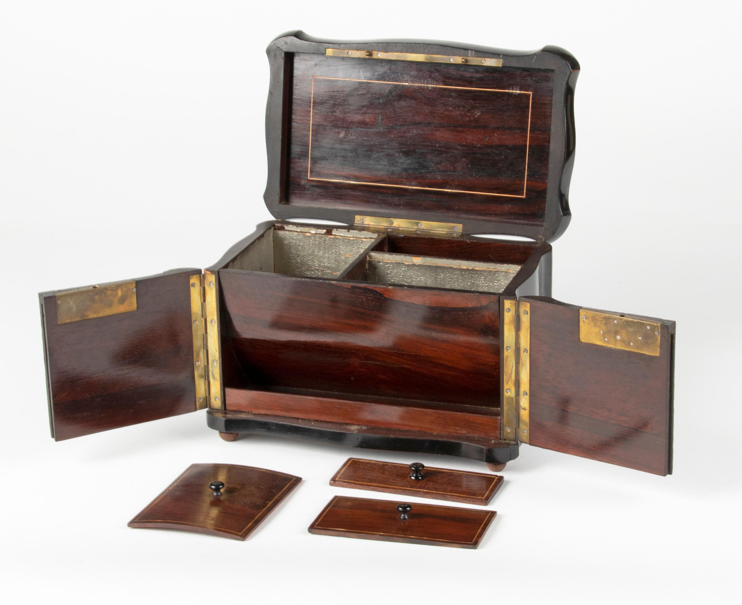 Beautiful antique Napoleon III tea box, crafted of black ebonised wood. The inlay is in Boulle style, marquetry of mother-of-pearl, brass and tortoise. The interior has tree compartments, with mahogany lids. On the front below a small storage