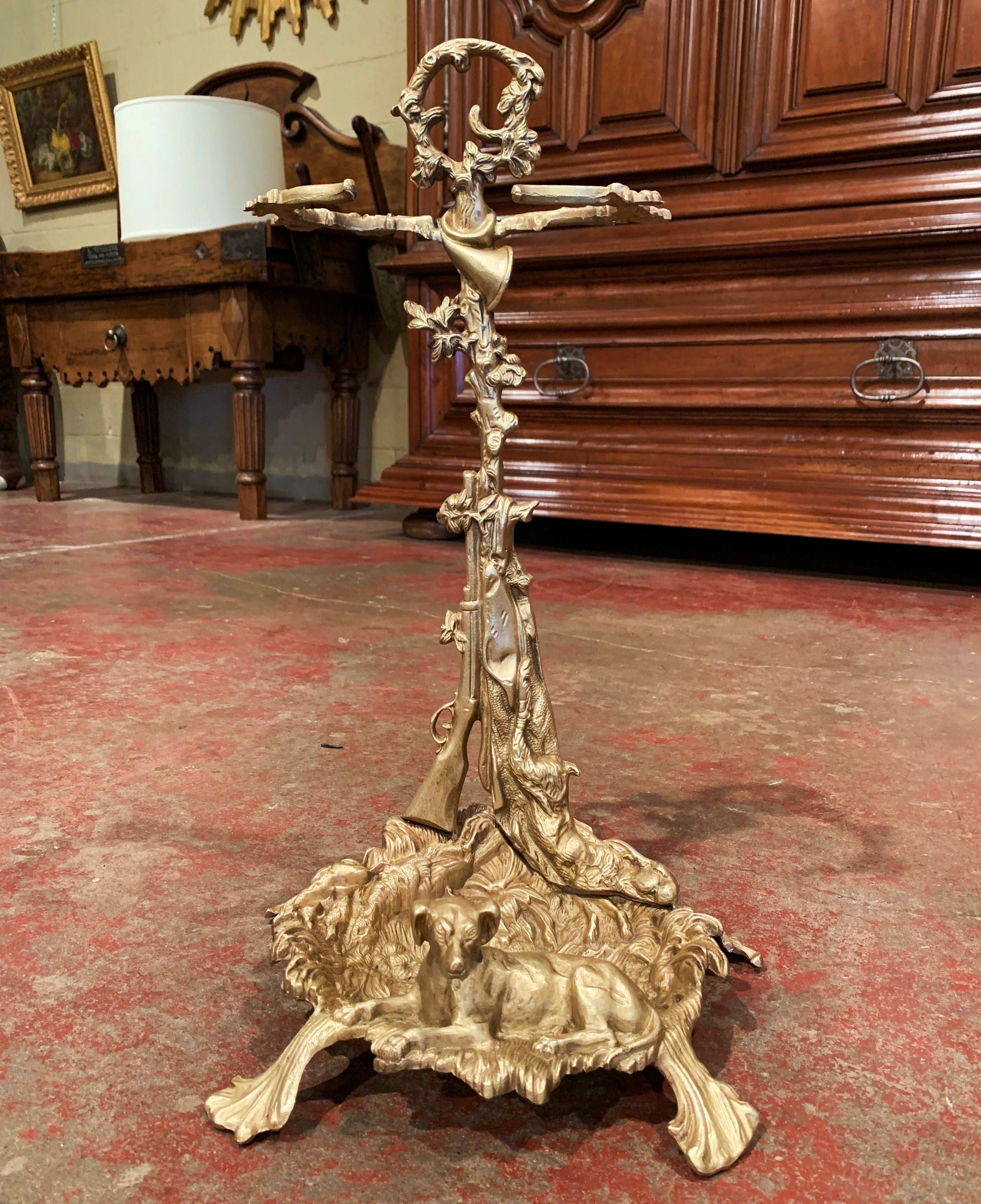 Decorate a hunting lodge with this fine antique umbrella or cane stand, crafted in France, circa 1870, the freestanding stand features a hunting theme including a horn at the top, a gun and a rabbit on the stem, and duck, partridge, foliage, and dog