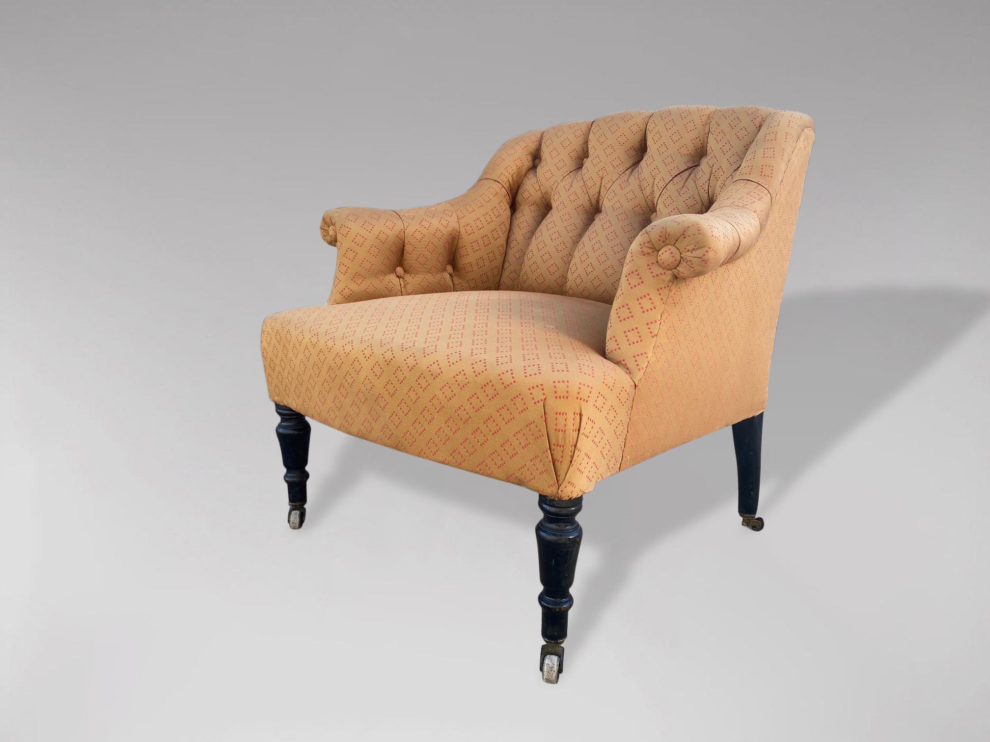 An attractive French 19th century Napoleon III upholstered armchair. Comfortable and supportive horse hair sprung seat with deep buttoned backs and armrests. Good solid frame. Raised on turned ebonised legs terminating in small original castors. The