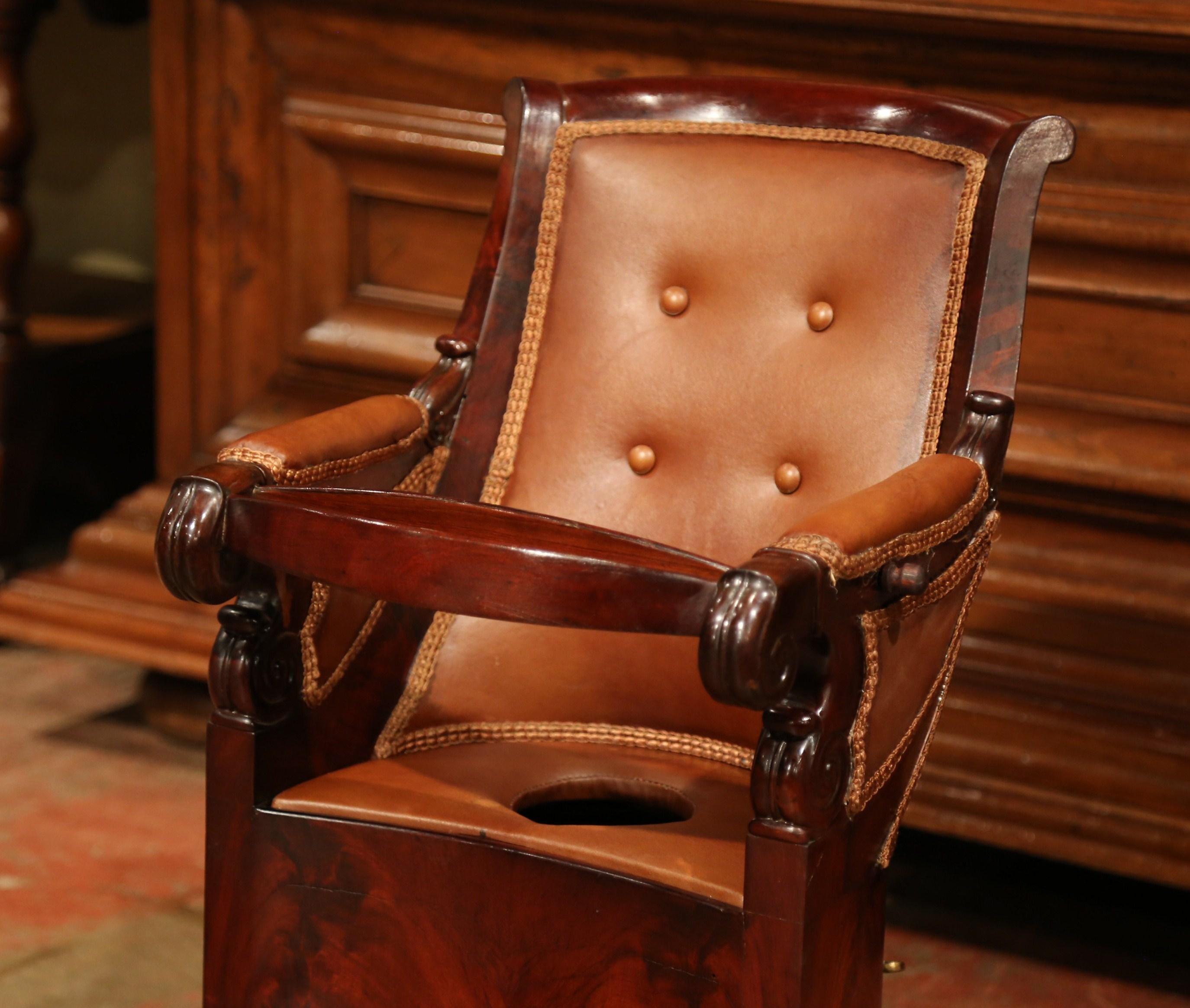 Bring royalty and elegance to your home with this antique baby chair, and treat your child like a king! Crafted in France circa 1870, the mahogany armchair with paw feet and wheels is a treasure on its own, not only does it have a lock mechanism