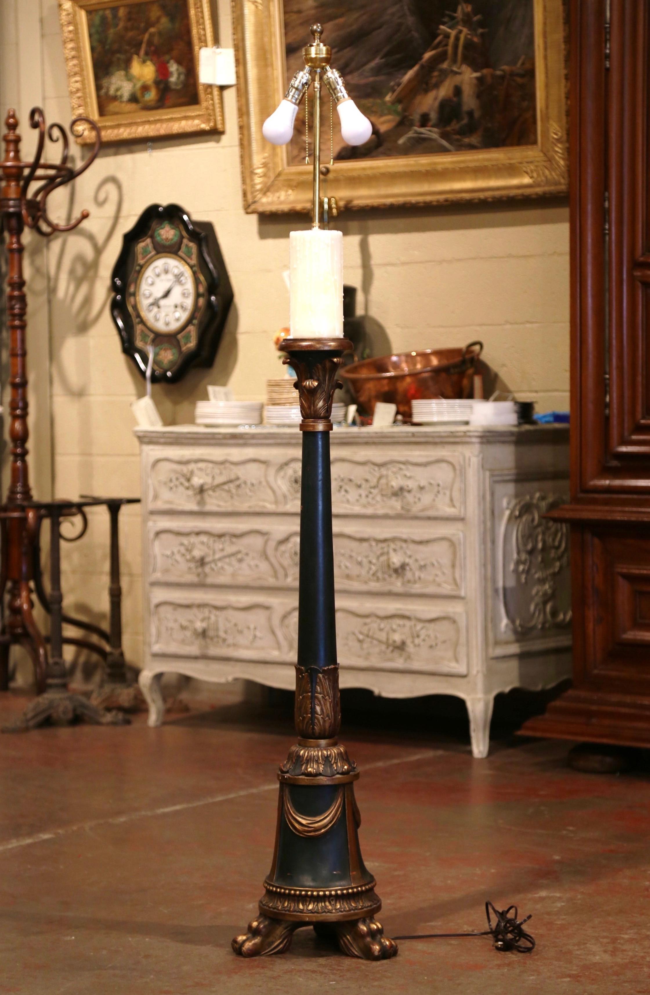This elegant antique carved lamp was crafted in France, circa 1880; the lamp stands on three paw feet over a round stem decorated with hand carved acanthus leaf and swag motifs. The fixture has new wiring with double lights, and is embellished with