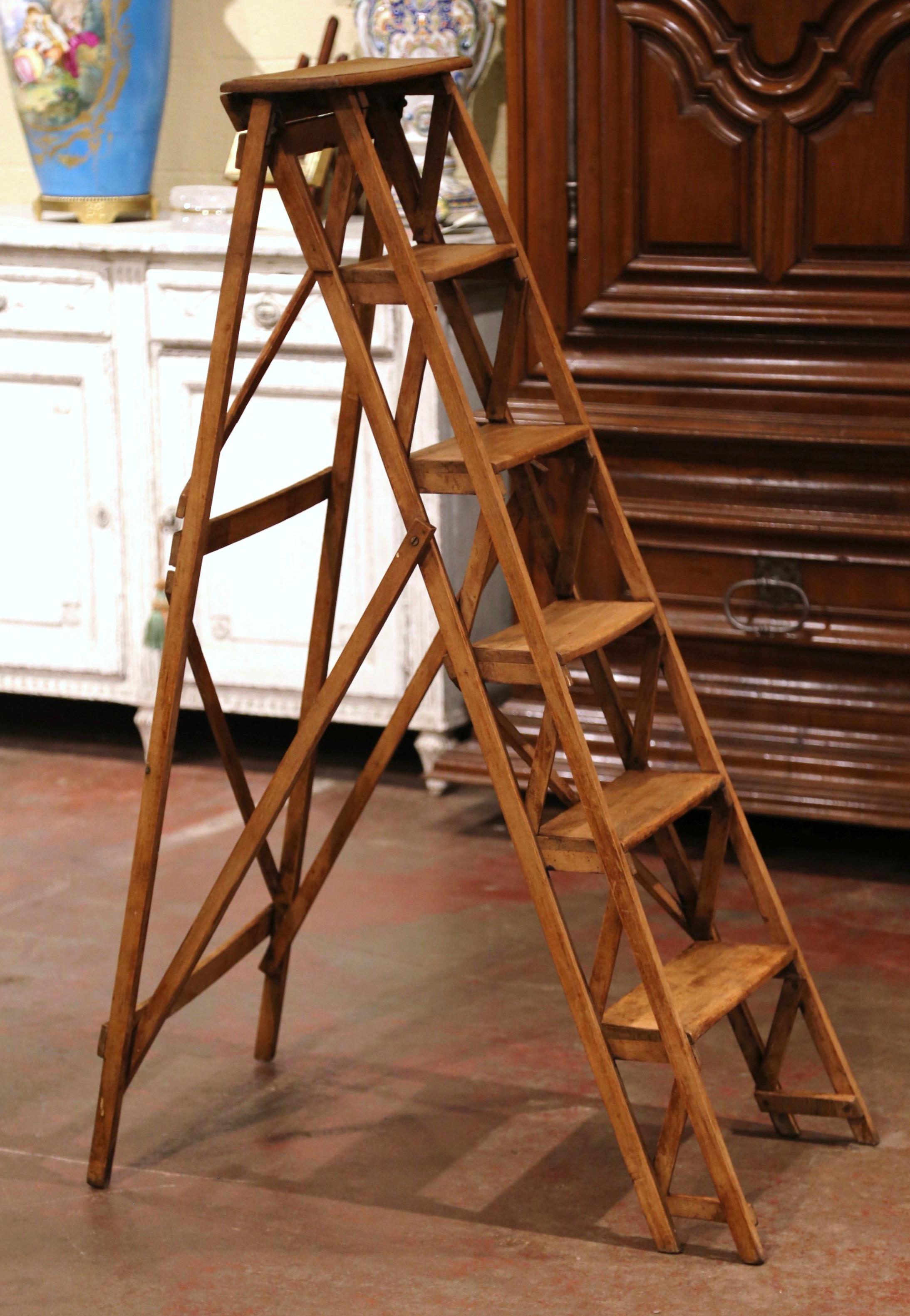 Crafted in France circa 1880 and made of walnut, the stairs features six graduated steps to one side and connected to the opposing support with a wooden and metal action folding mechanism. Practical and useful, the ladder can folded and put away if