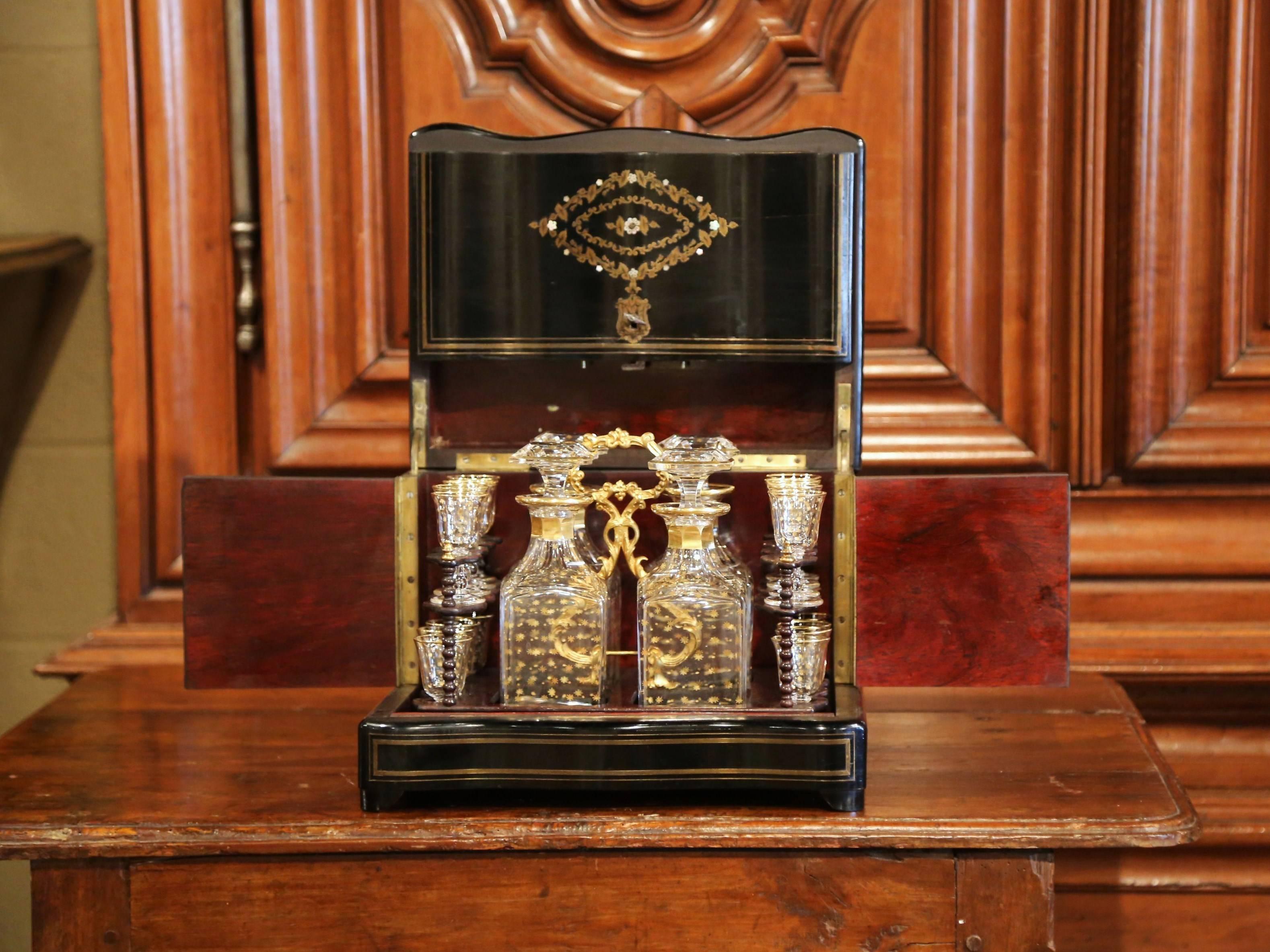 Create an elegant bar area with this antique and complete liquor box. Crafted in France, circa 1870, the rectangular cave has a beautiful mother of pearl inlay medallion on the front and on the top, and is further embellished by brass inlay decor