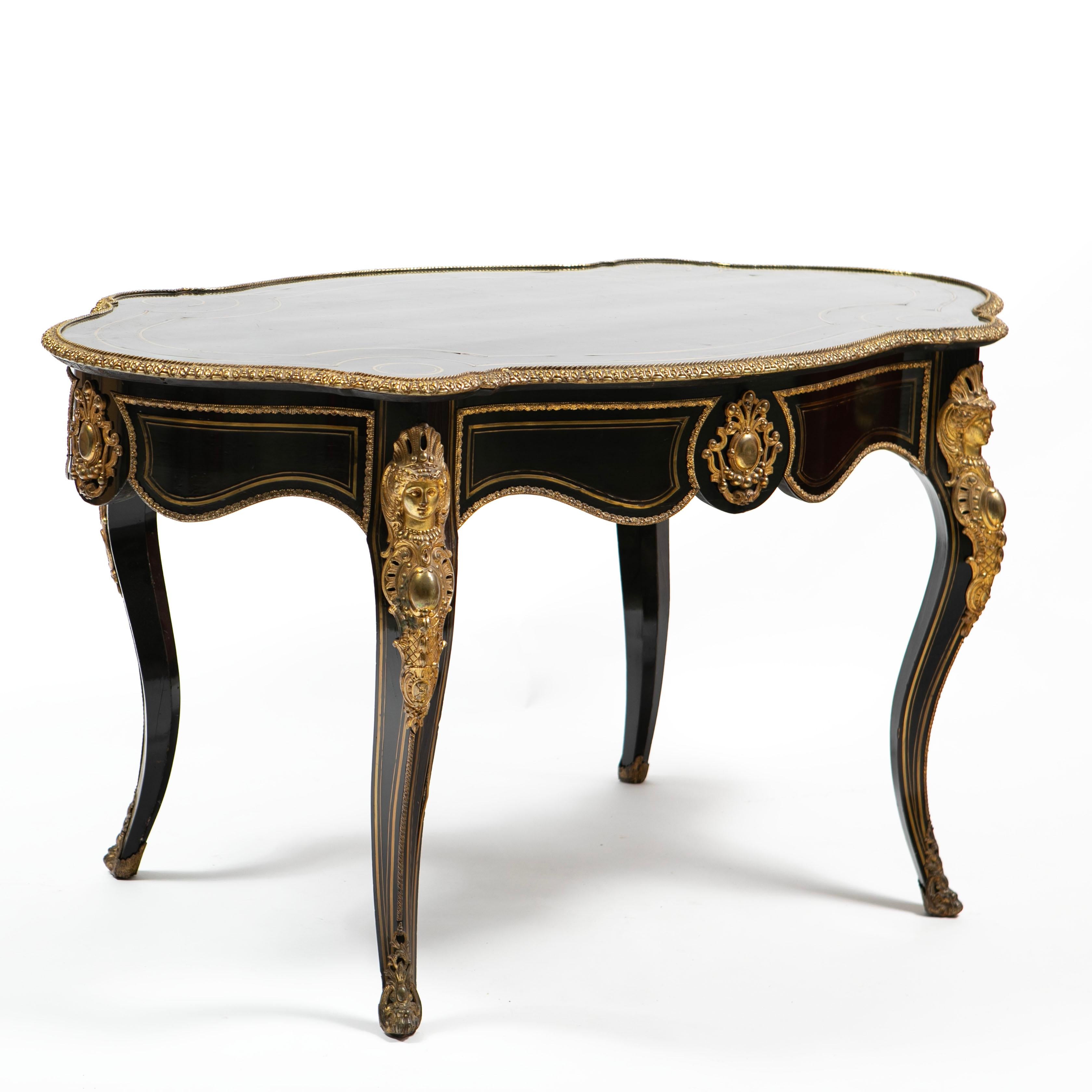 A French Napoleon III serpentine console table or salon table in ebonized wood with elaborate and fine ormolu details.
Four cabriolet legs, each leg decorated with an ormolu mount of a female figure. The table has a single drawer on the apron and