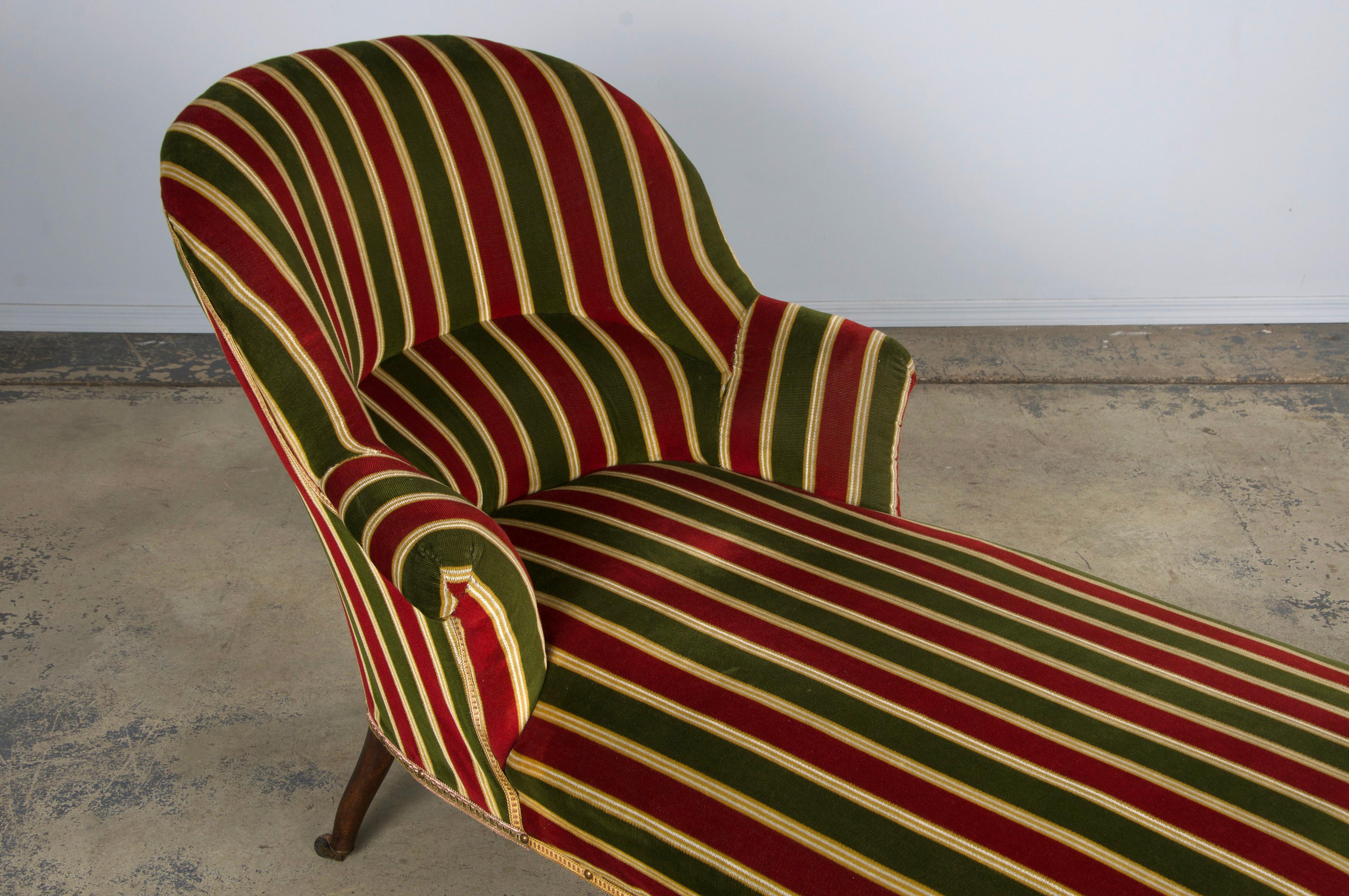 A traditional late 19th-century Napoleon III chaise lounge or daybed, sourced from Provence, France. Beautifully handcrafted from solid maple, it features an elegant oval-back frame with graceful scroll arms. Structurally restored, the chaise