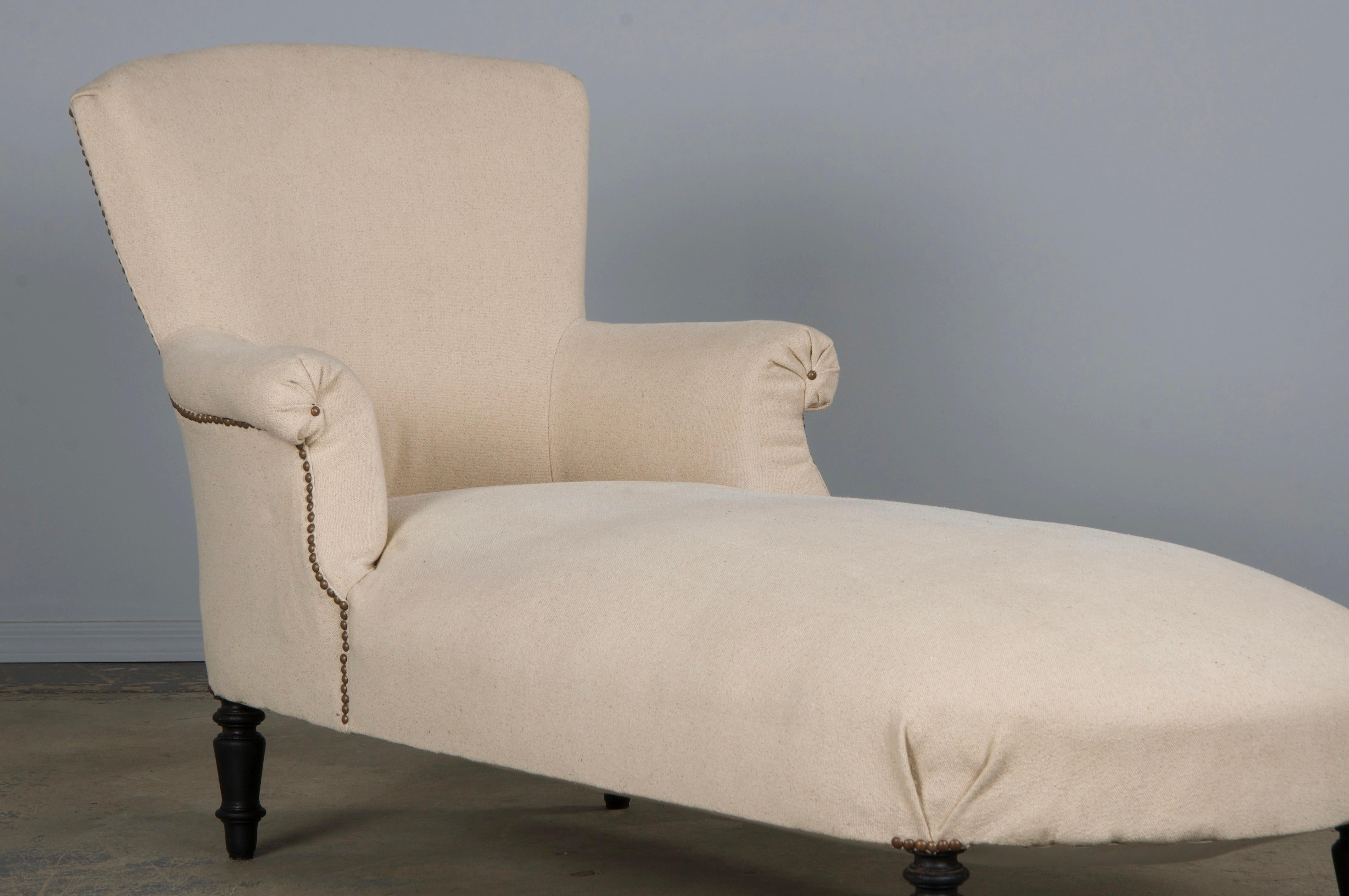 An elegant late 19th-century French Napoleon III chaise lounge, sourced from Provence, France. Expertly handcrafted from solid wood, it features a refined square back and gracefully curved arms. The chaise has undergone a structural restoration in