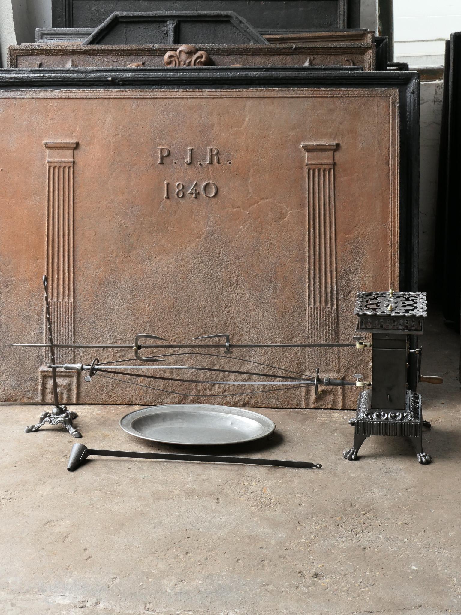Functional and beautiful 19th century French Napoleon III roasting jack made of cast iron, wrought iron, brass and copper. It is used for cooking in a kitchen fireplace. The set consists of a clockwork roasting jack, one spit for chicken and one