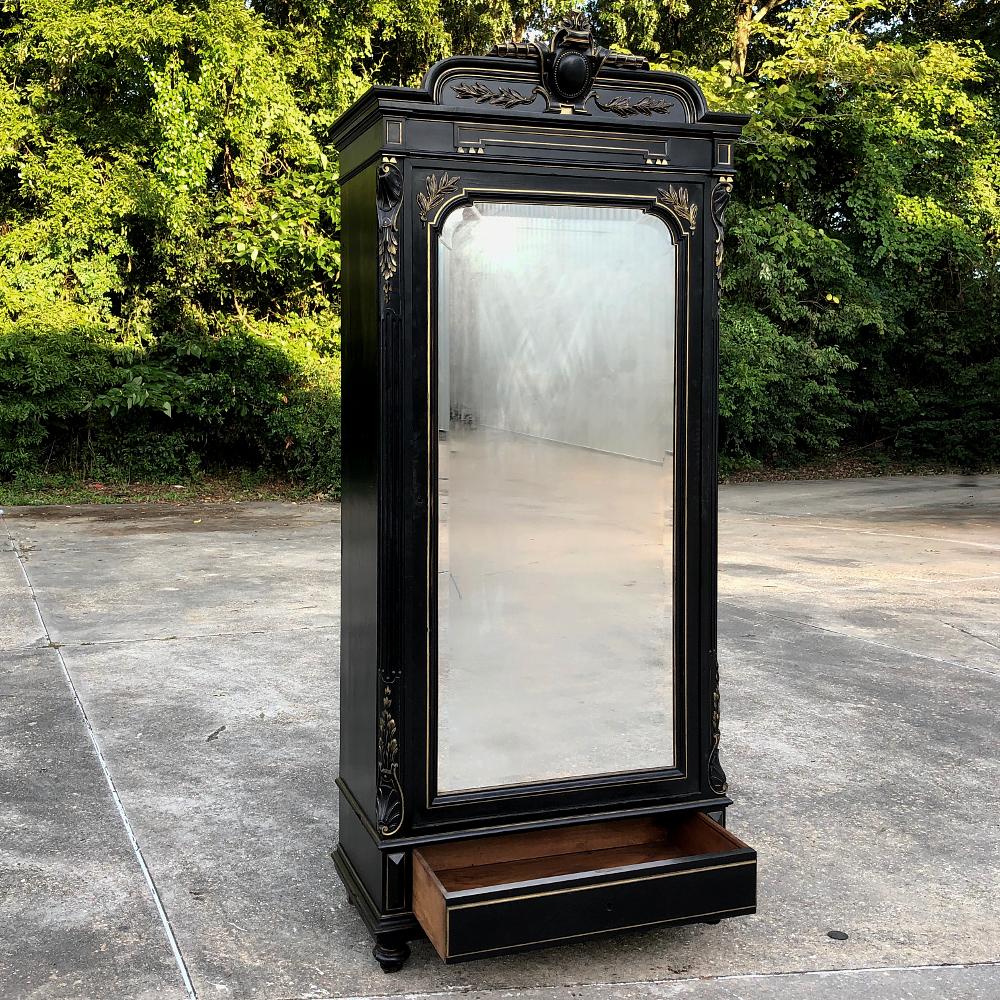 19th century French Napoleon III ebonized armoire was considered the essence of elegance during the reign of the last monarch of France! Fine walnut was treated to a process similar to japanning which leaves a polished black ebony appearance. The