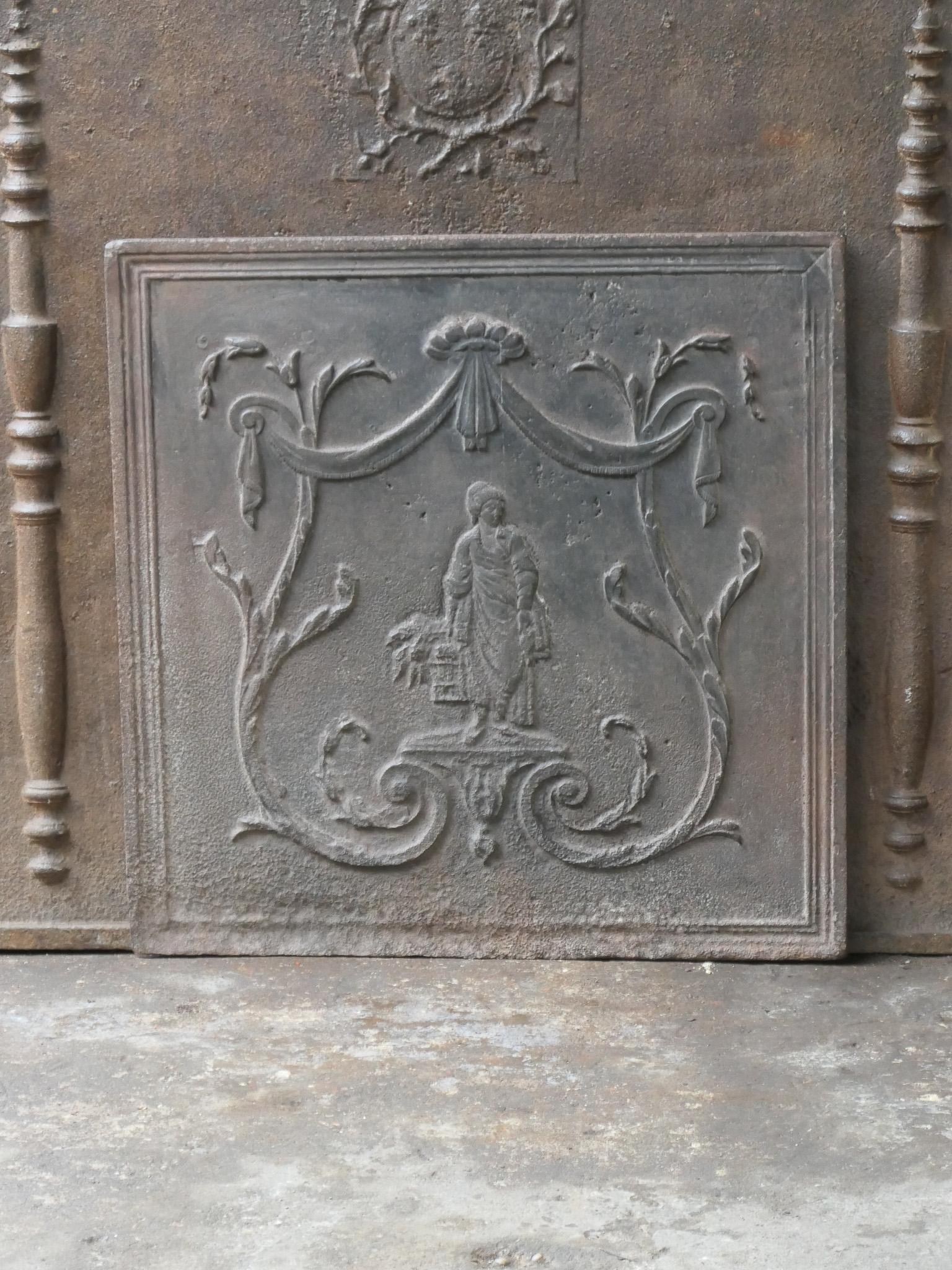 19th century French fireback with an unknown scene with a woman carrying produce from the market or garden. 

The fireback has a natural brown patina. Upon request it can be made black / pewter. It is in a good condition, without cracks.
