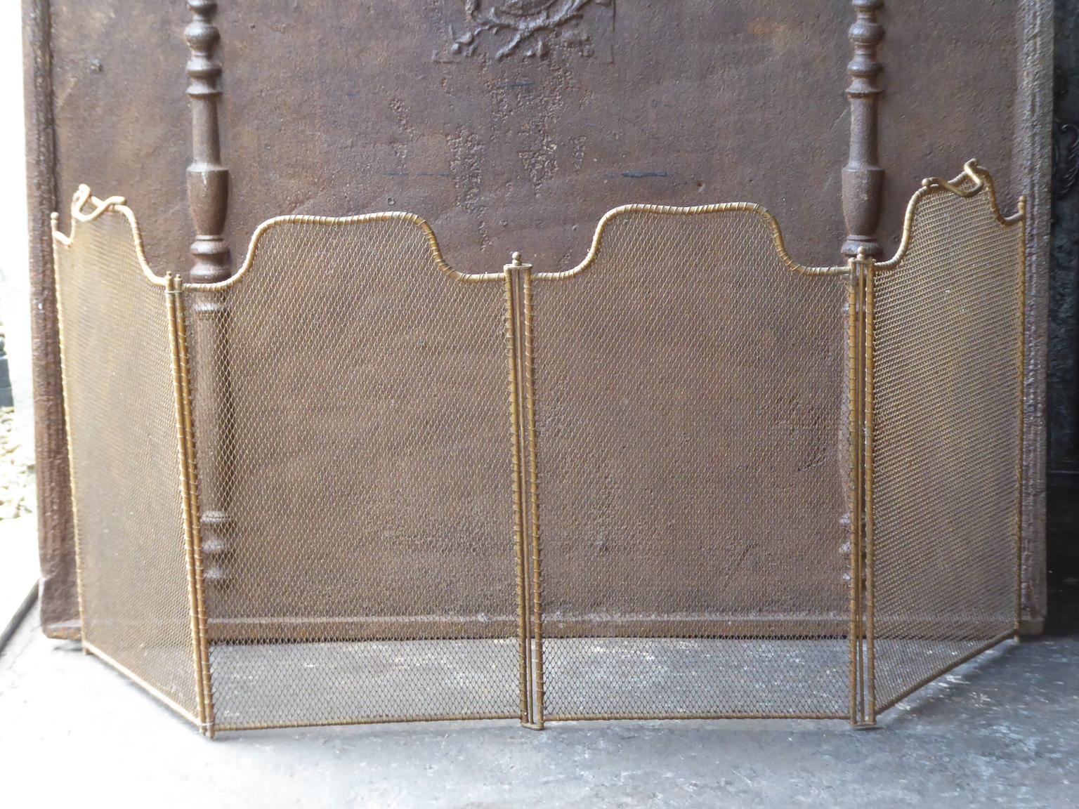 19th century French Napoleon III four panel fireplace screen. The screen is made of brass, iron and iron mesh. It is in a good condition and is fit for use in front of the fireplace.