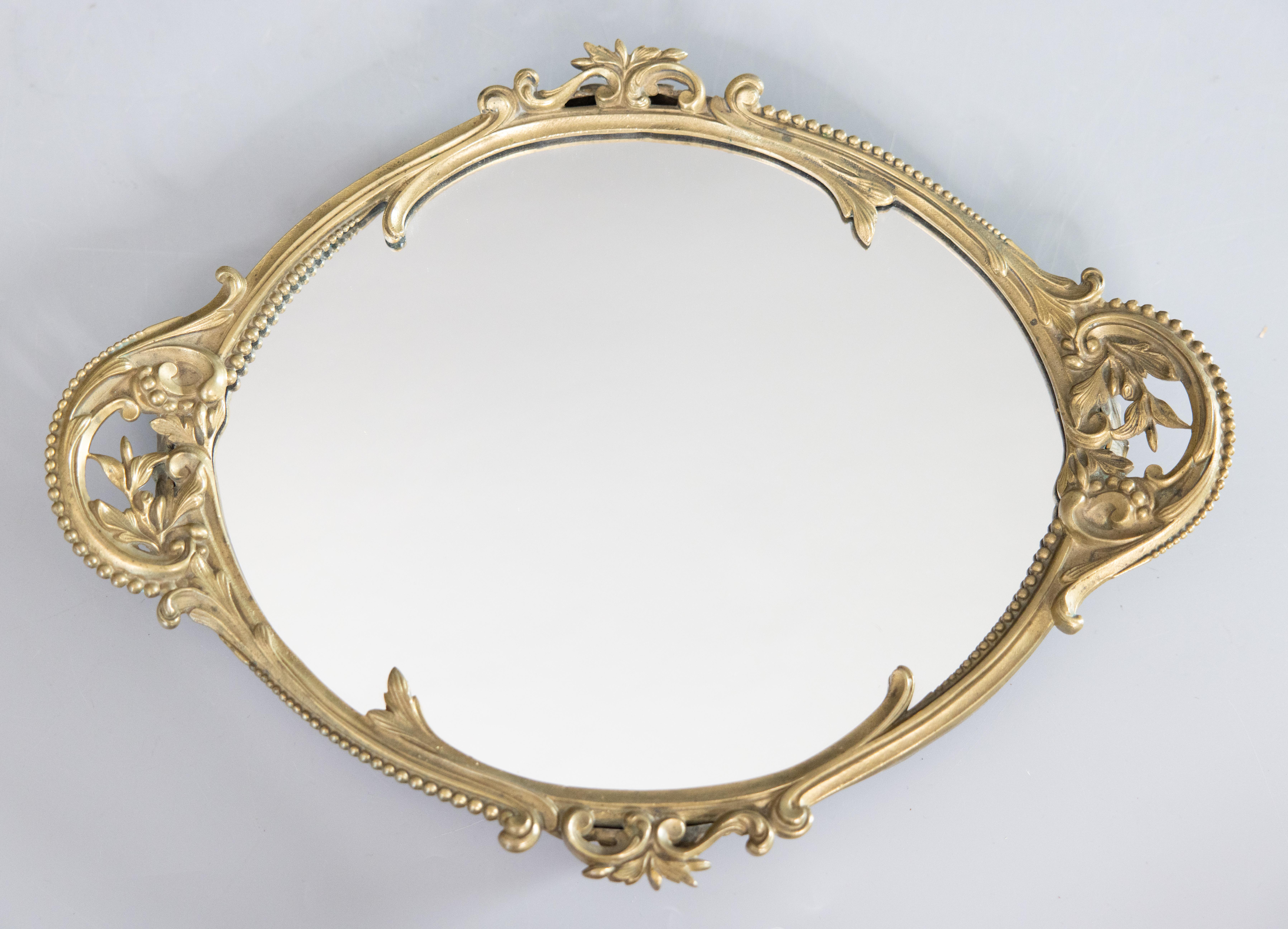A superb 19th Century French Napoleon III period gilded bronze mirrored table plateau footed tray with ornate handles, foliate and floral details, beaded trim, and lovely gilt patina. It would look gorgeous displayed on a buffet with wine glasses,