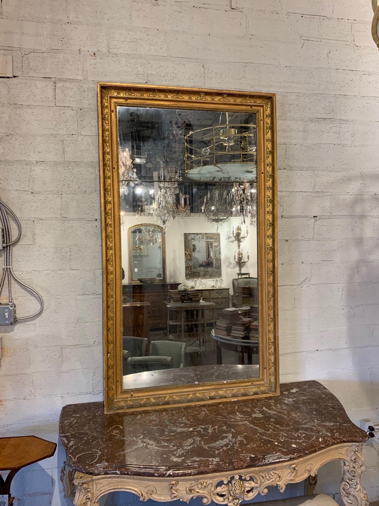 Elegant 19th century French Napoleon III giltwood mirror with original divided mercury glass. Beautiful decorative design on the giltwood. So pretty!