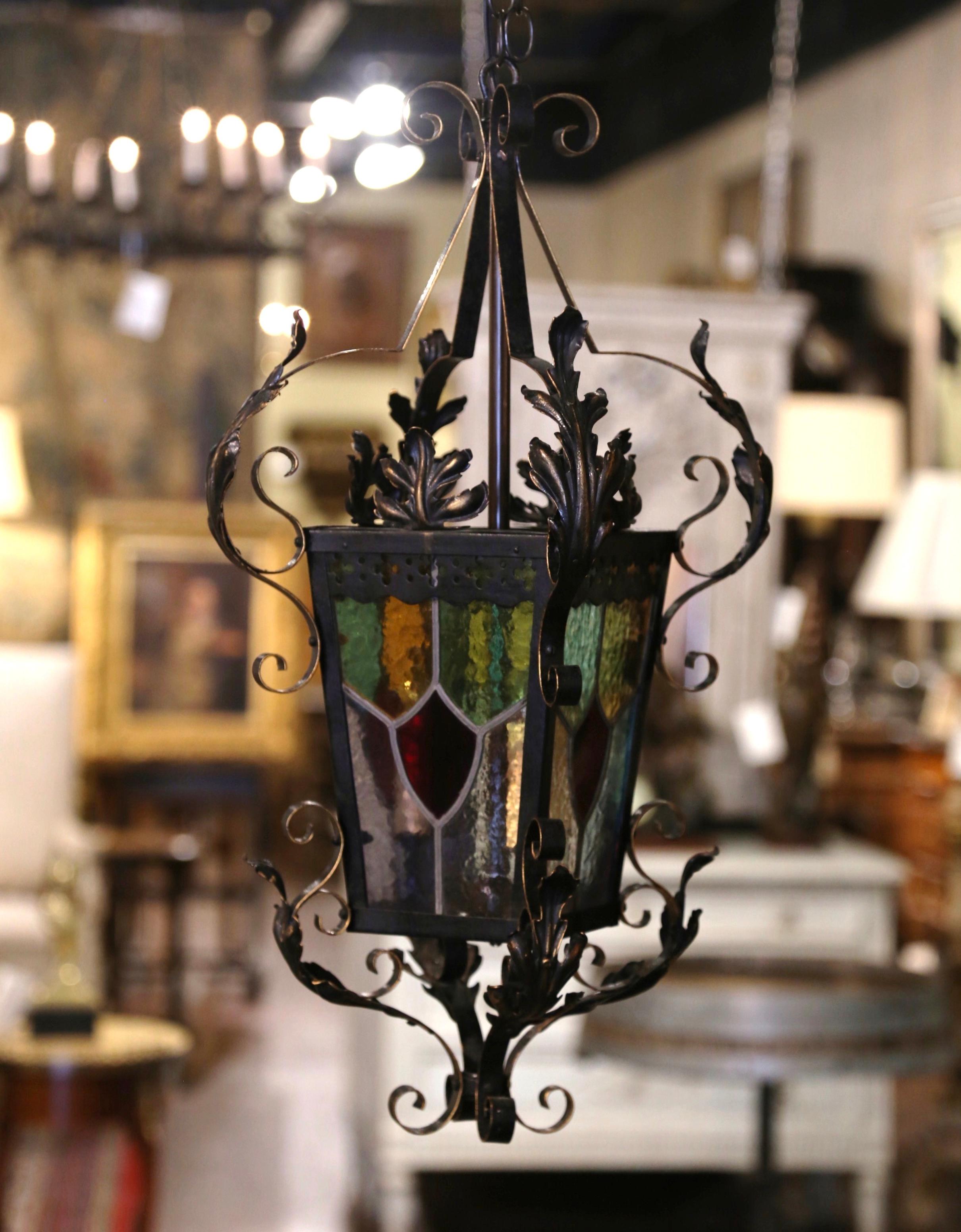 For a unique lighting feature, look no further than this beautiful, antique Gothic lantern. Created in France circa 1870, the lantern is decorated with four painted, stained glass panels including a small door to access the light bulbs; the frame is
