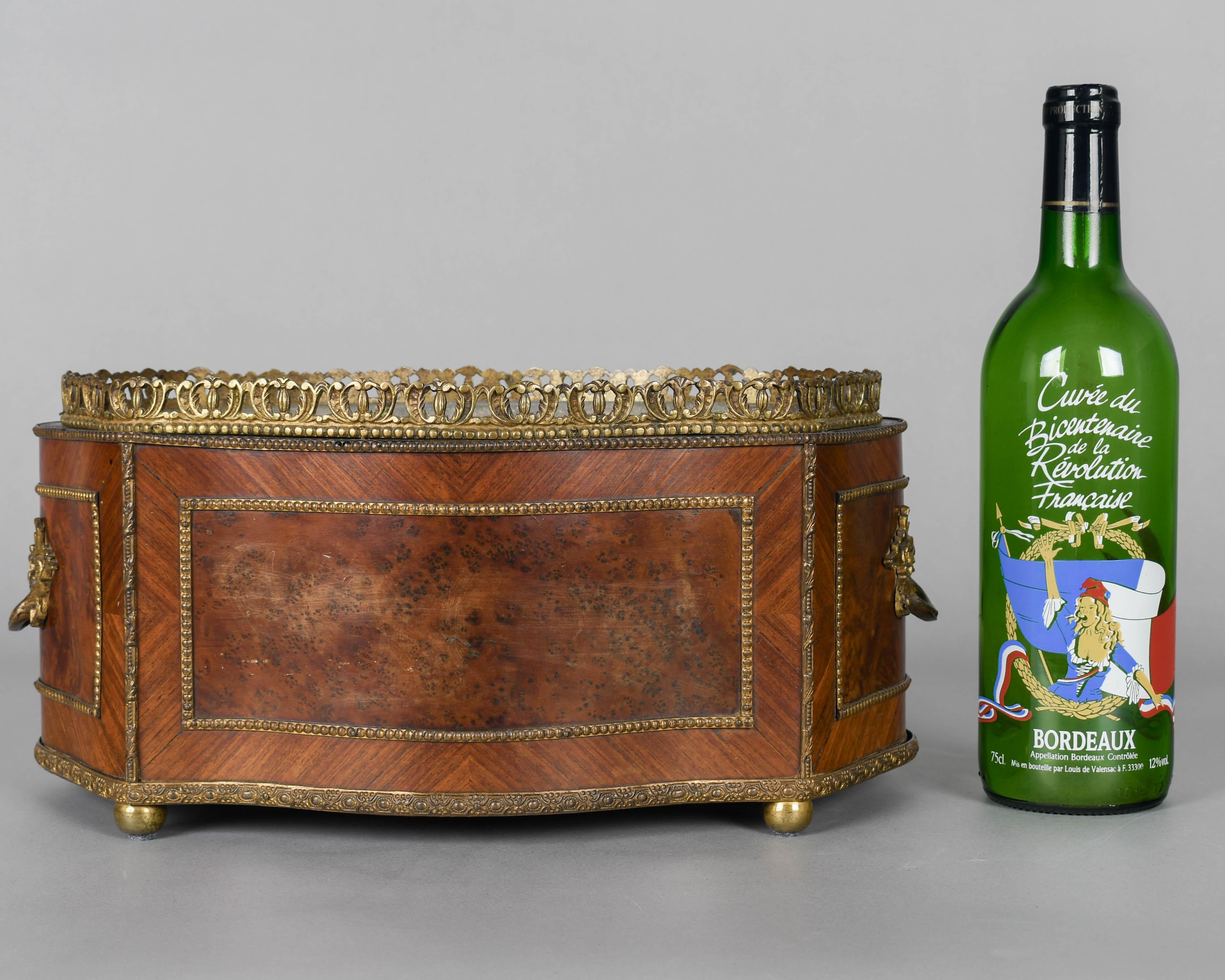 A late 19th century French Napoleon III marquetry jardinière with inlaid veneers of burled walnut and mahogany. Bronze-mounted with two handles, gallery and bead trim. Zinc liner is not water tight. A beautiful planter for the display of orchids.