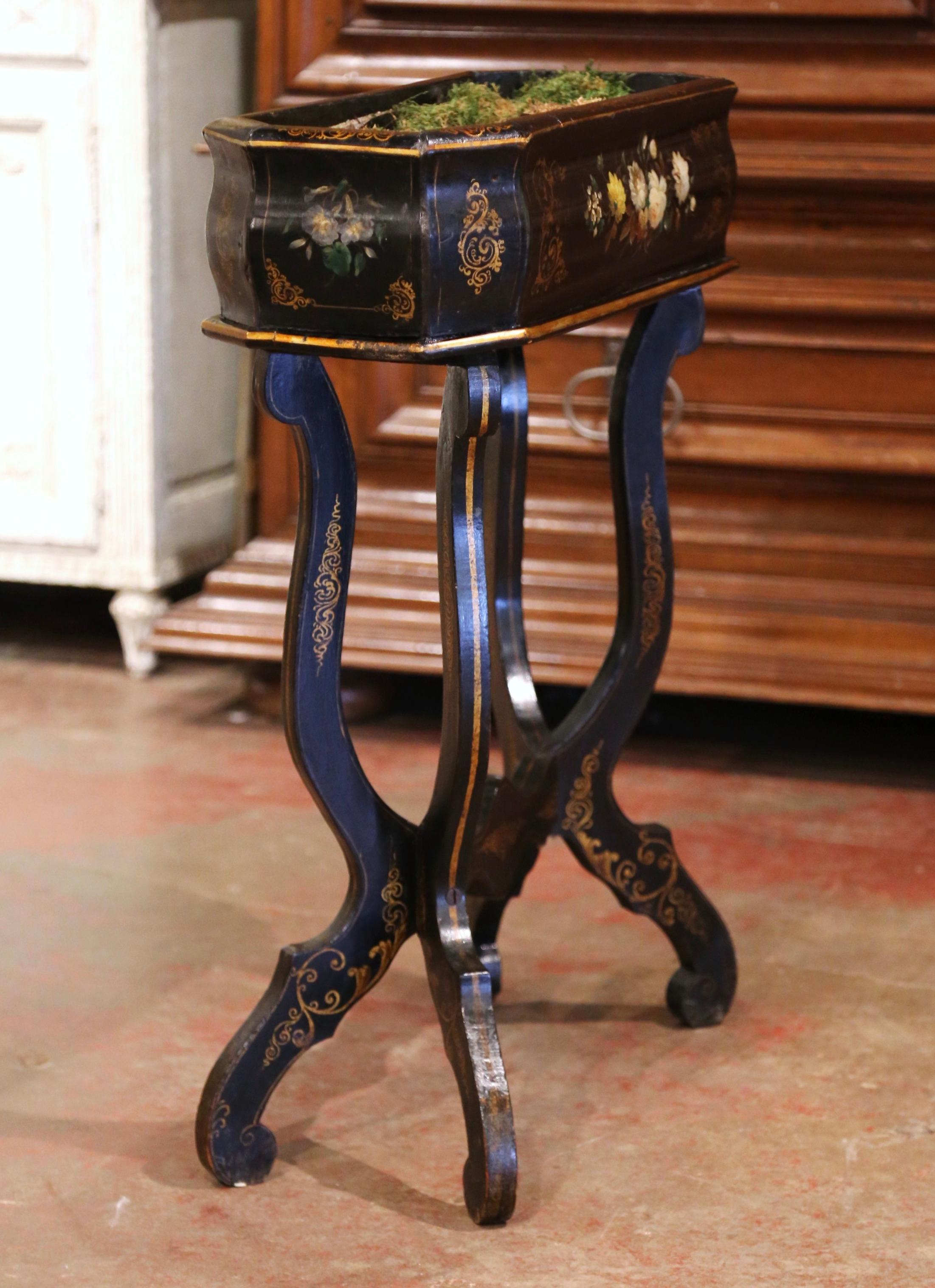 This elegant antique planter was created in France, circa 1870. Standing on four curved legs ending with scrolled feet over a bottom stretcher, the rectangular and bombe blackened jardiniere is decorated with colorful hand-painted floral motifs on