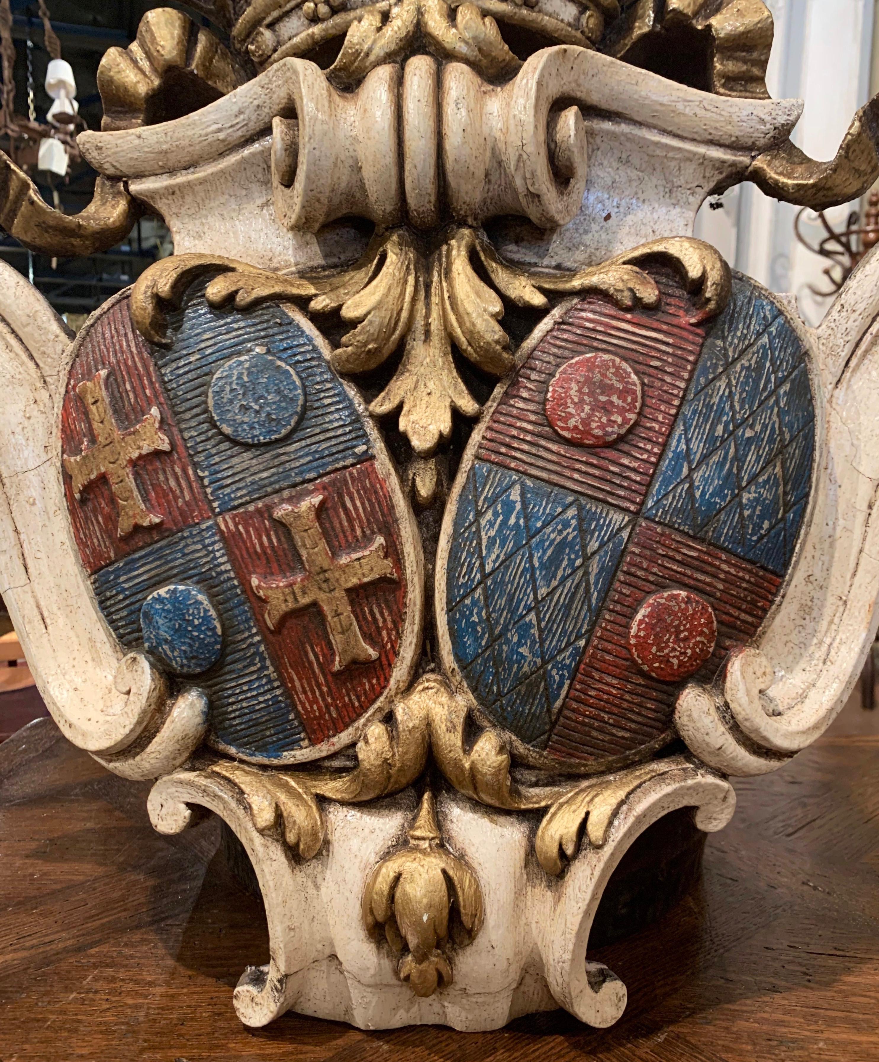 Decorate an office or a study with this elegant antique coat of arms. Crafted in France, circa 1880, the large hand painted crest features a count crown at the pediment flanked with ribbon on the sides over scroll and acanthus leaf motifs. Two oval