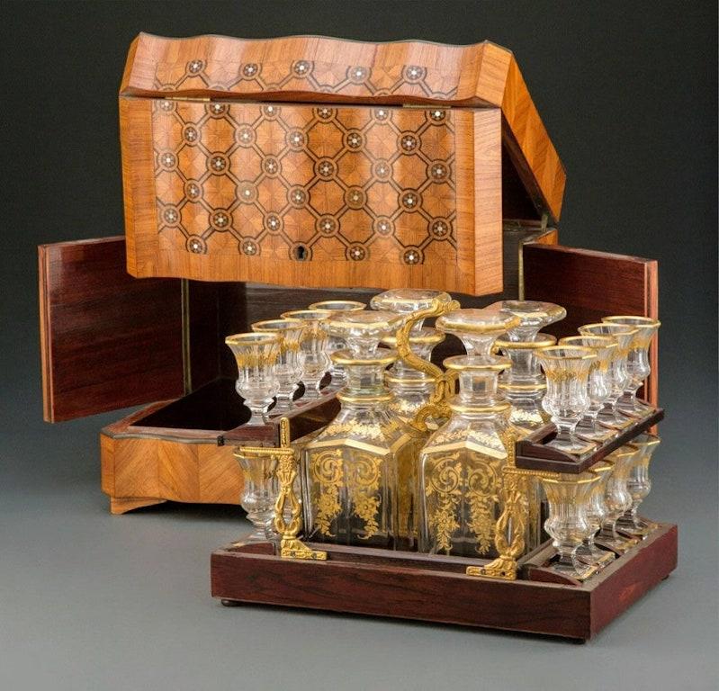 A period twenty piece French liquor cellar with Baccarat crystal attributed partial gilt glass barware, Paris, France, mid-19th century.

The magnificent classical French Cave à Liqueur Set is of the finest master craftsman quality, richly