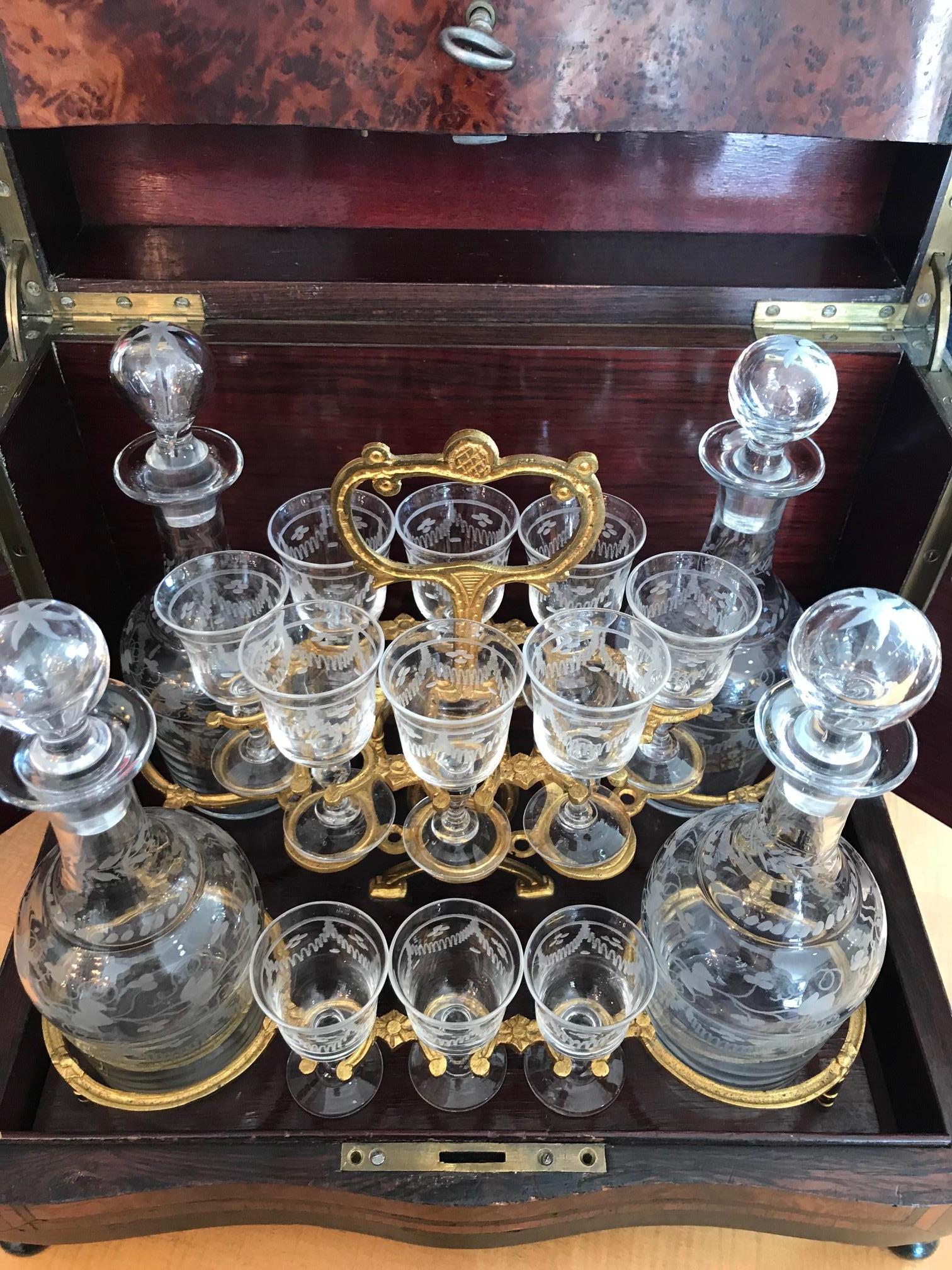 Beautiful 19th century French Napoleon III period liquor cellar from the 1850s.
Set of four crystal carafe and eleven crystal glasses (3 glasses missing) in a gilded brass basket with a handle. Very good condition. Gilded brass fitting.
The box