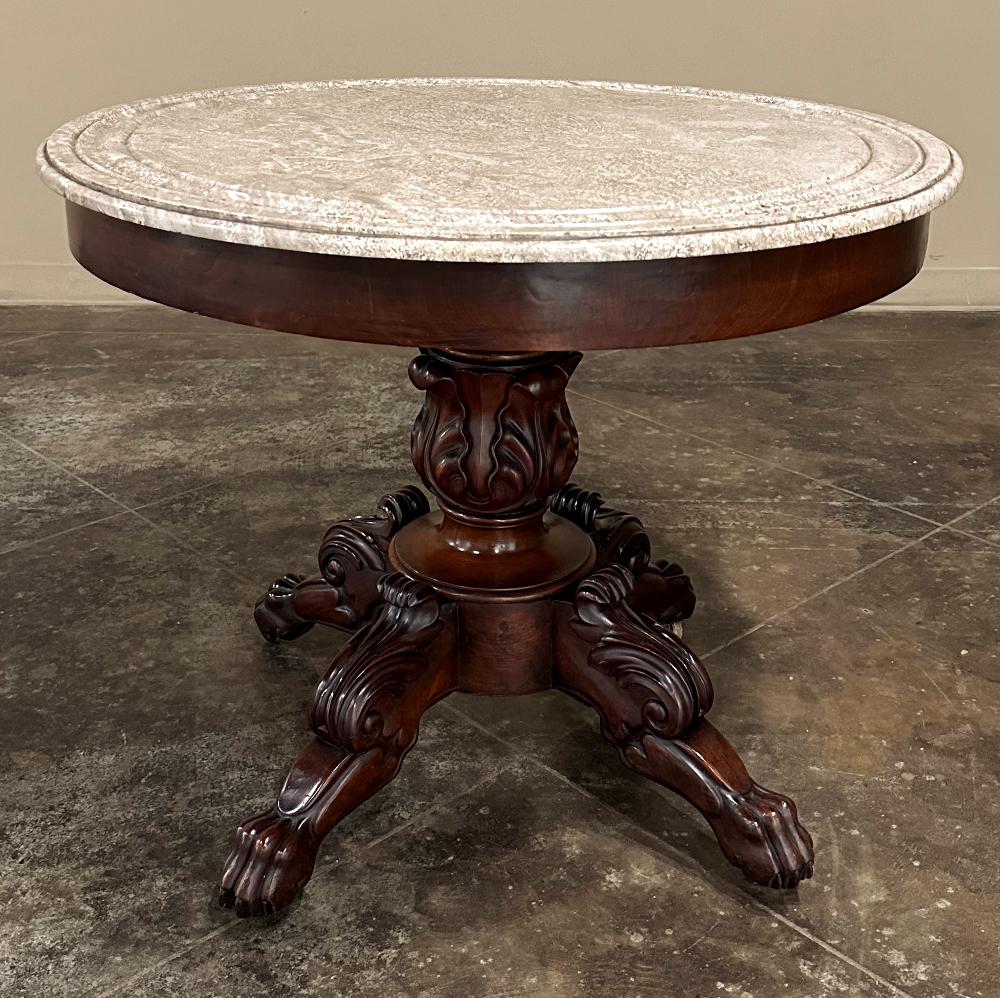 19th Century French Napoleon III Period Mahogany Marble Top Center Table was designed to impress all who enter the home.  Hand-crafted from exotic imported mahogany, it features a bold pedestal carved with acanthus plumes supported by four boldly