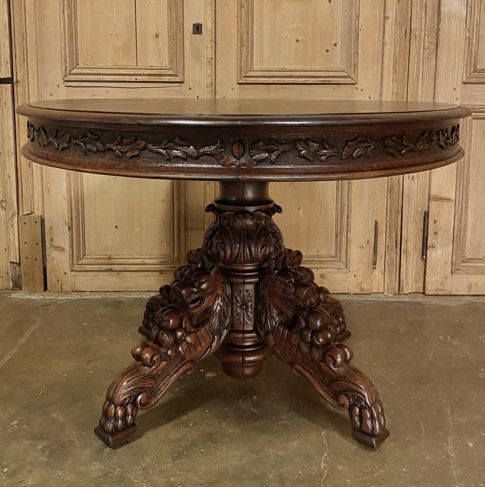 19th century French Napoleon III period oval center table is a masterpiece of naturalistic beauty! Artistically sculpted from dense, old-growth indigenous oak, it features a dupont bevel on the top edge overlooking an apron carved around its
