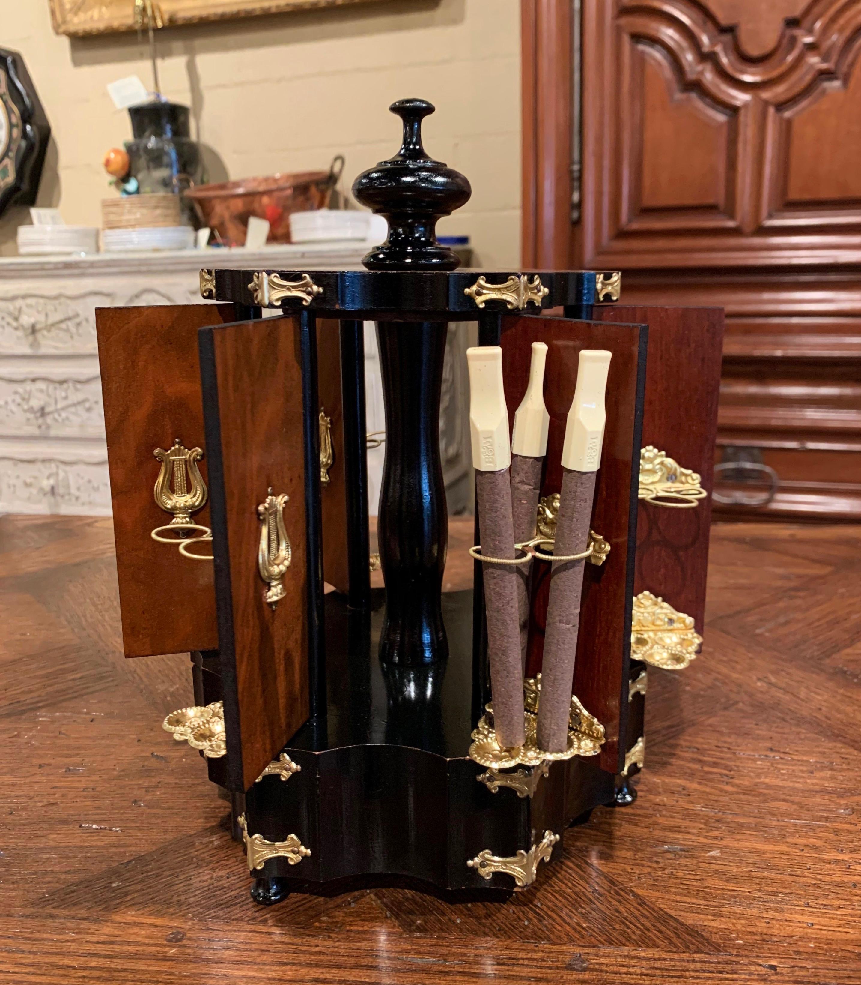 This elegant antique two-tone fruitwood box was crafted in France, circa 1870; the twelve-cigar holder stands on small bun feet, and features a top finial knob with rotating open and close mechanism when twisting the knob. The outside of all six