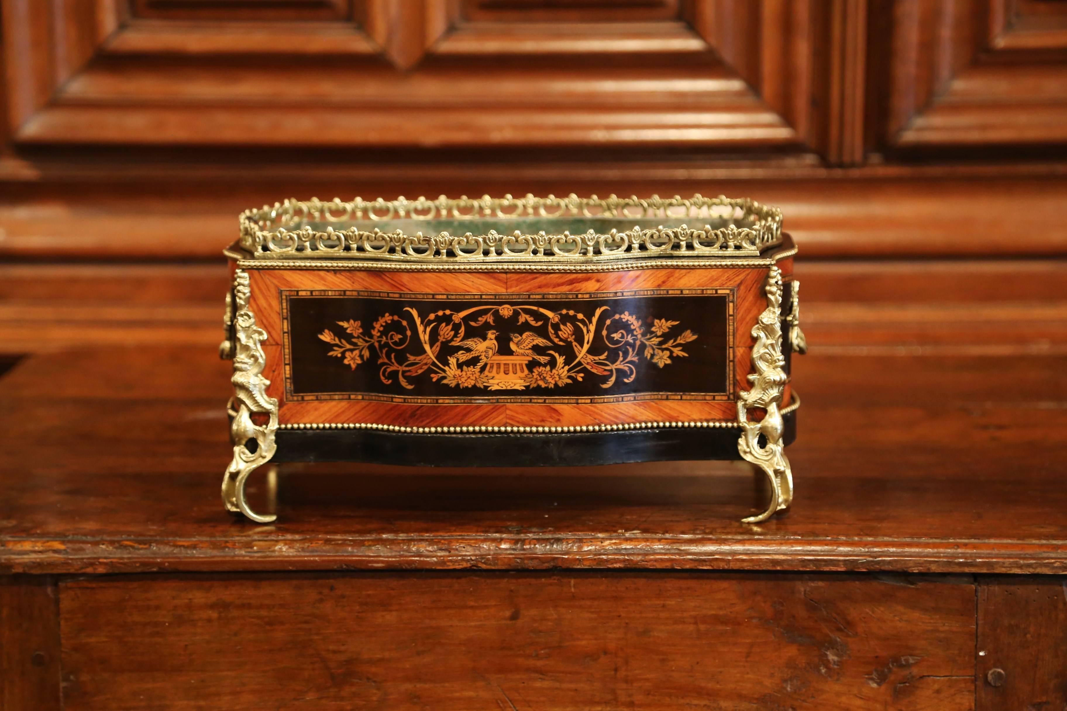 This beautifully crafted, antique fruitwood jardinière was crafted in Paris, France, circa 1870. Rectangular in shape with bow sides, the rosewood and ebony planter features wood marquetry and parquetry decor with very detailed inlay work of a