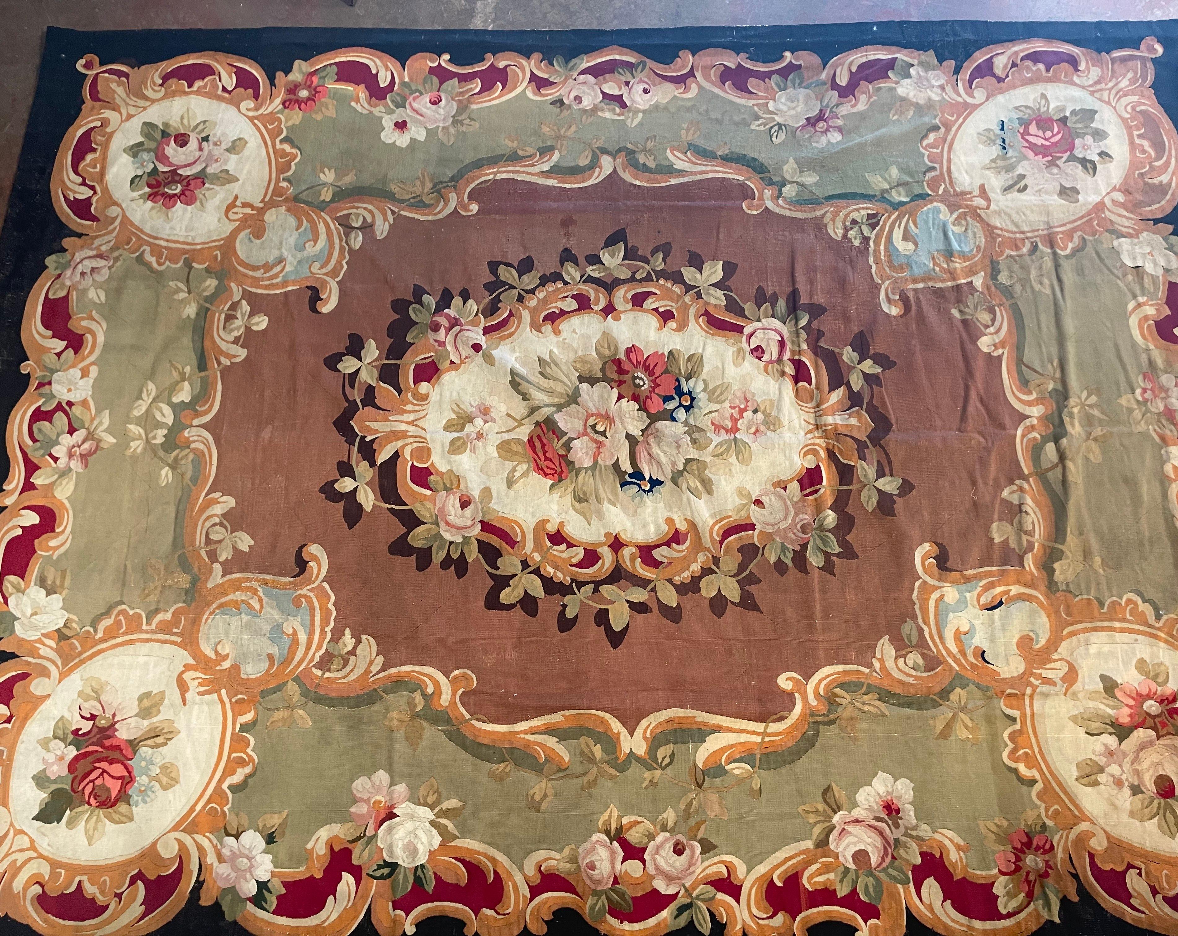 Decorate a dining room or living room with this beautifully kept antique Aubusson rug, coming straight from a chateau in southern France. Hand woven in the city of Aubusson circa 1870, the 13 x 10 colorful carpet features scroll and floral motifs