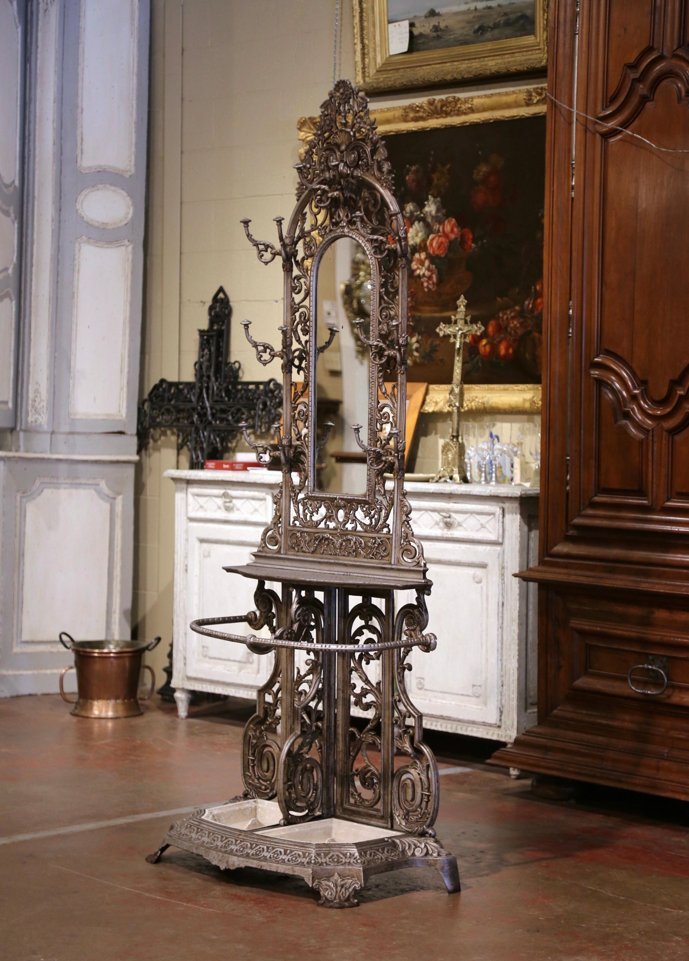 Place this elegant antique hall tree in an entry or a mud room to catch coats, hats and umbrellas. Crafted in France circa 1870, the tall Napoleon III free standing halltree sits on a half moon base ending with paw feet, and decorated with floral