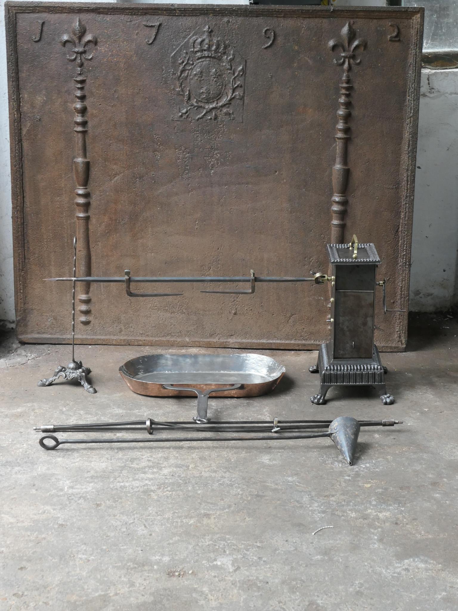 Functional and beautiful 19th century French Napoleon III roasting jack made of cast iron, wrought iron, brass and copper. It is used for cooking in a kitchen fireplace. The set consists of a clockwork roasting jack, a spit for chicken and a spare