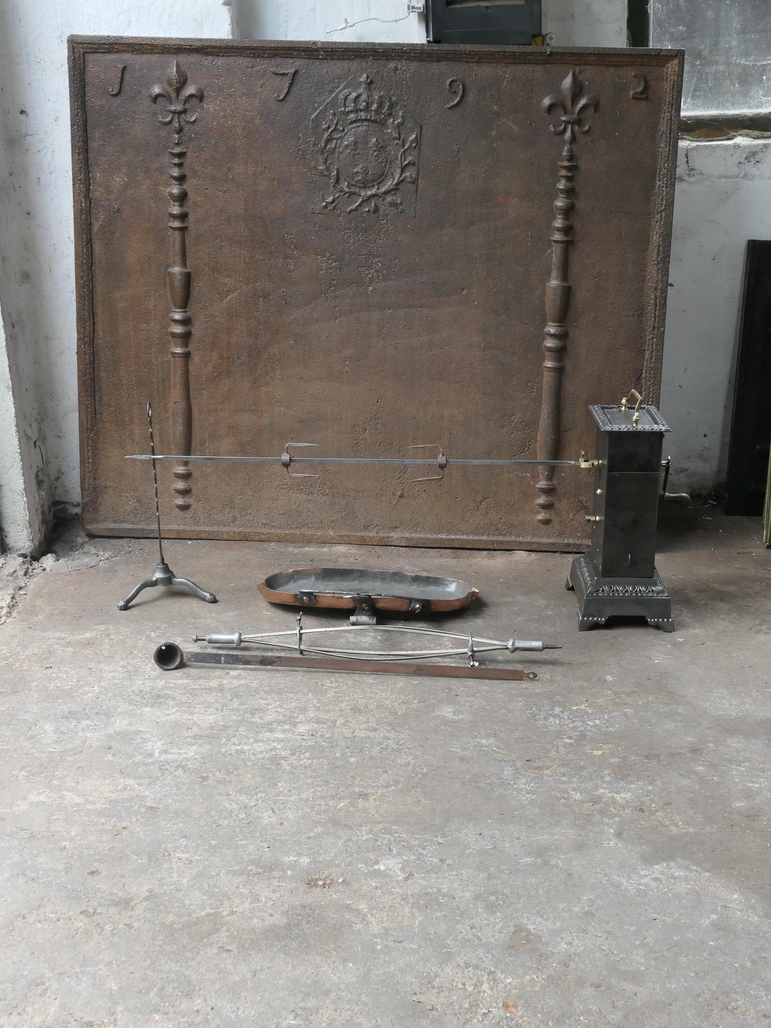 Functional and beautiful 19th century French Napoleon III roasting jack made of cast iron, wrought iron, brass and copper. It is used for cooking in a kitchen fireplace. The set consists of a clockwork roasting jack, a spit for chicken and a spare