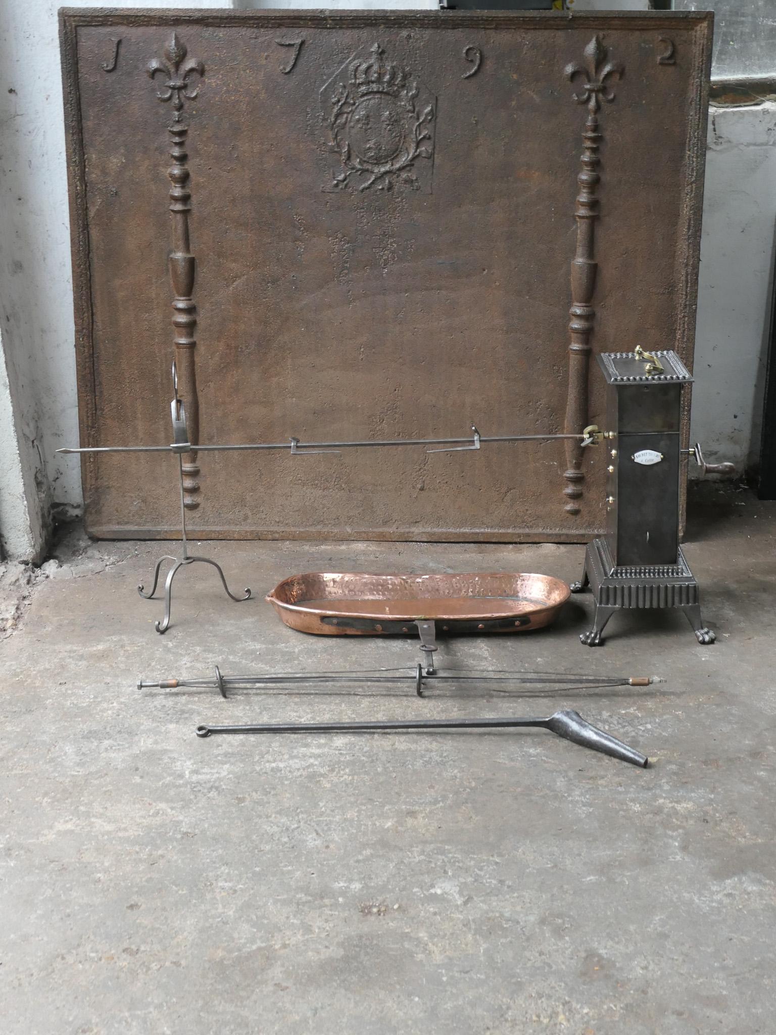 Functional and beautiful 19th century French Napoleon III roasting jack made of cast iron, wrought iron, brass and copper. It is used for cooking in a kitchen fireplace. The set consists of a clockwork roasting jack, a spit for chicken and a spare