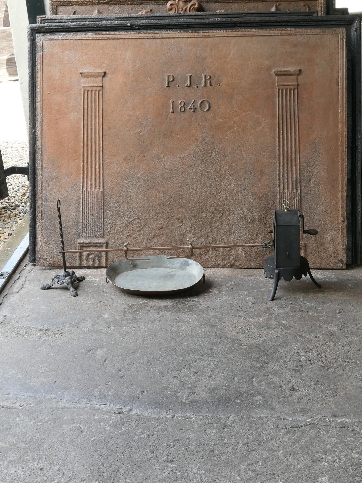 Functional and beautiful 19th century French Napoleon III roasting jack set made of cast iron, wrought iron, brass, and copper. It is used for cooking in a kitchen fireplace. The set consists of a clockwork roasting jack, a spit for poultry, a stand