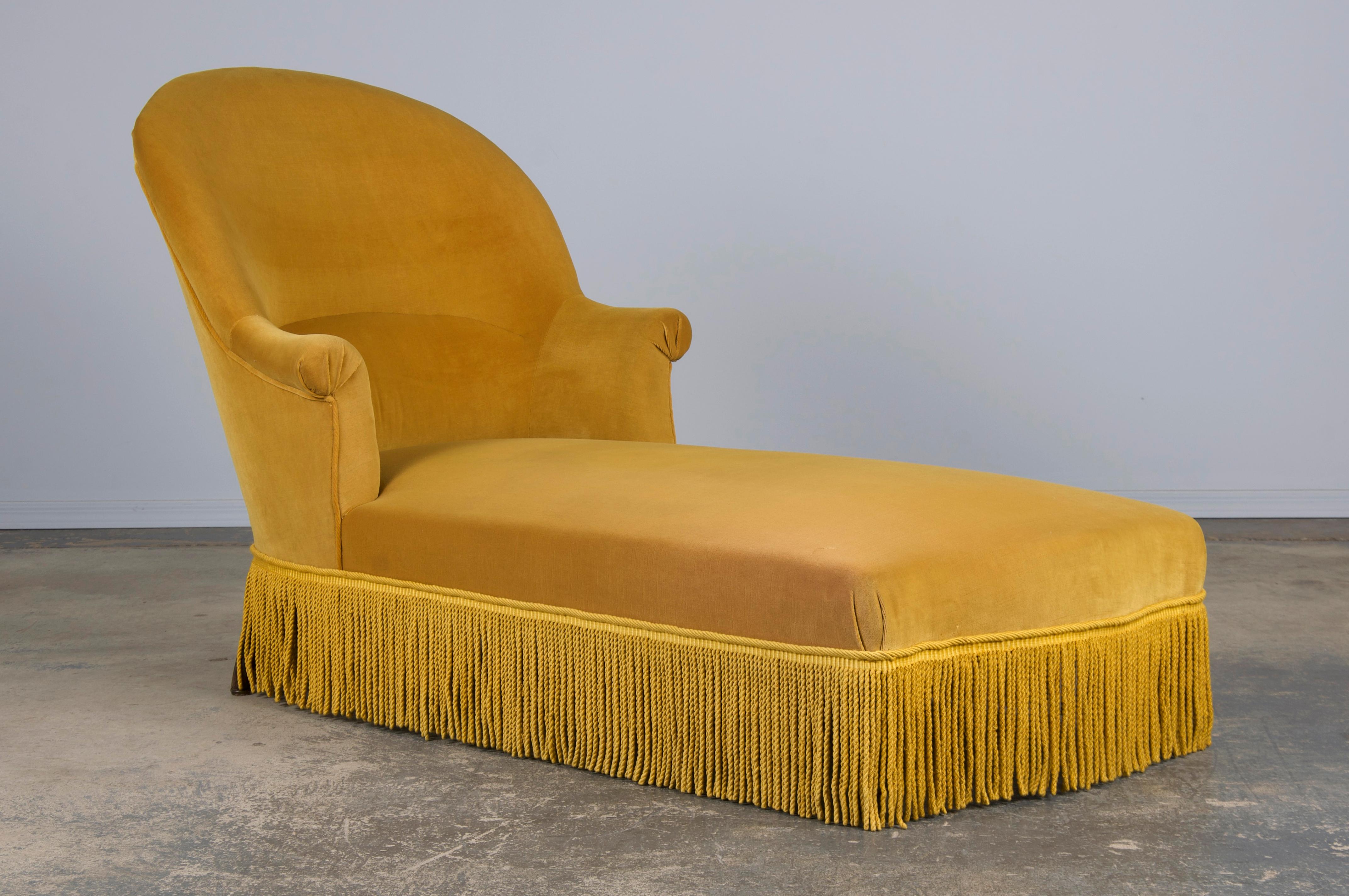 A traditional late 19th-century Napoleon III chaise or daybed lounge, sourced from Provence, France. Beautifully handcrafted from solid wood, they feature elegant oval-back frames with scroll arms. Structurally restored, the chaise retains its