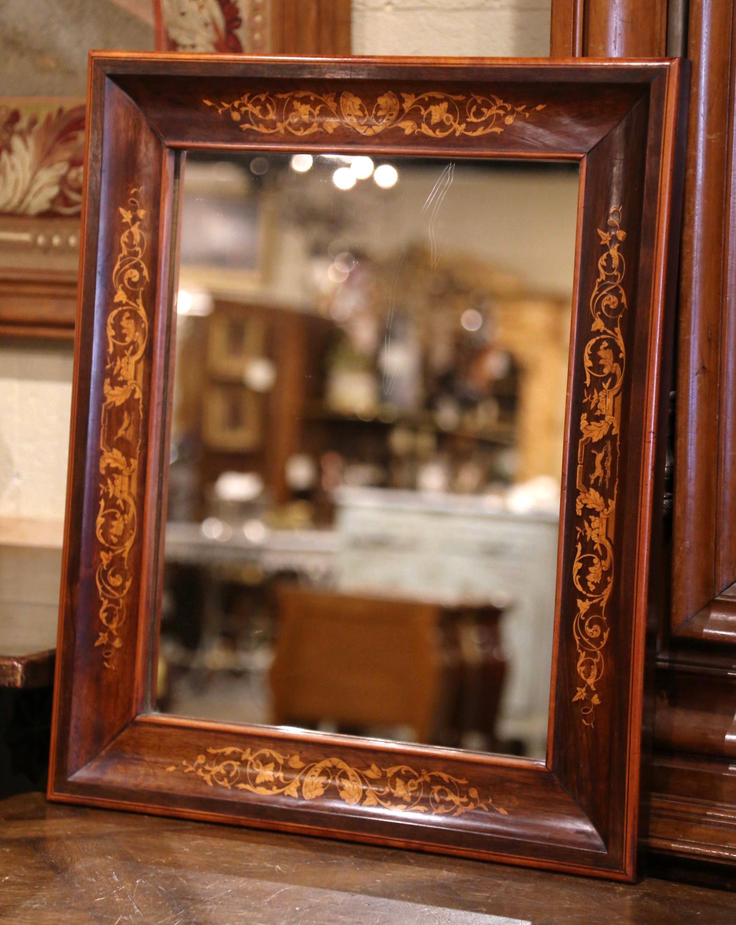 Versatile, this petite mirror could be hung horizontally or vertically in a number of rooms for a traditional Napoleon III French style. Crafted in Paris France, circa 1890, and built of walnut wood, the antique mirror has traditional, timeless